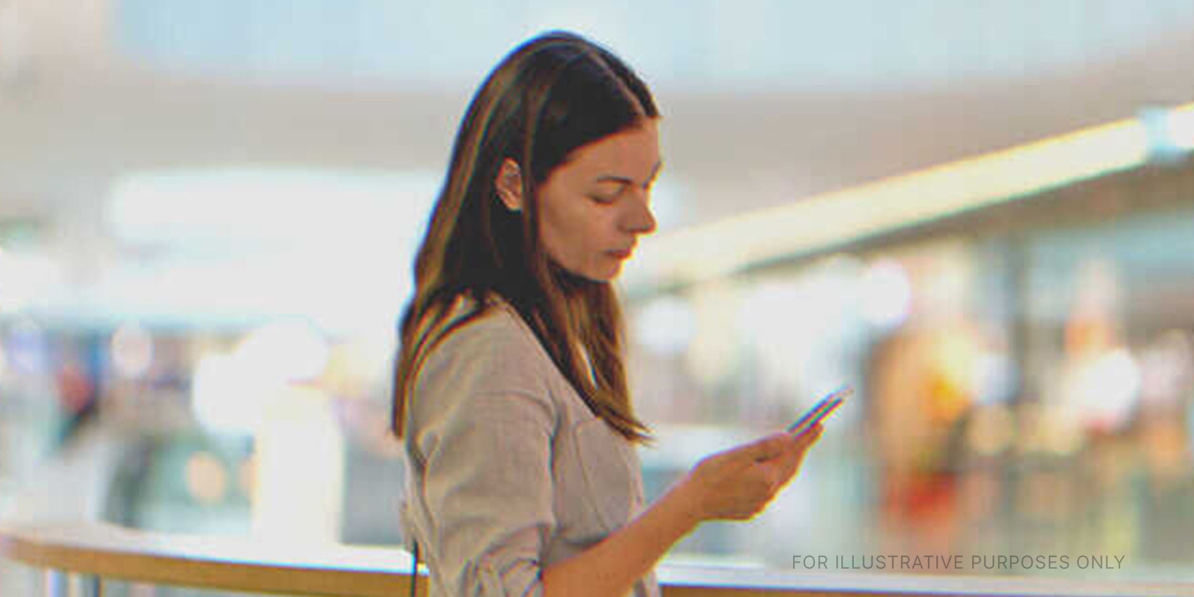Woman using her cellphone. | Source: Shutterstock