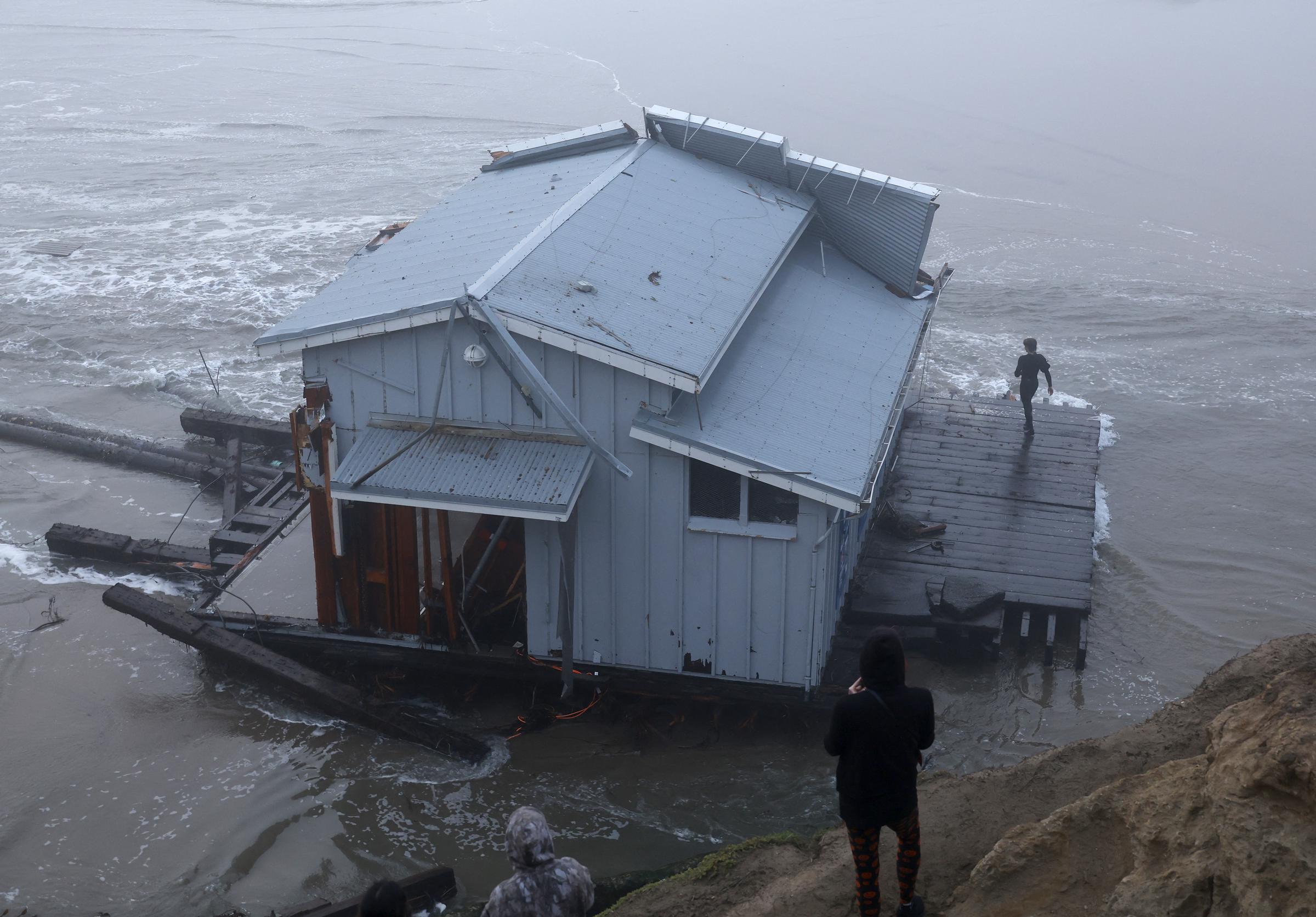 People look at the collapsed pier at the Santa Cruz Wharf in Santa Cruz, California, on December 23, 2024 | Source: Getty Images