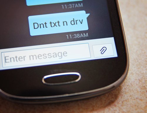 Gros plan du message texte avertissant de ne pas envoyer de message texte et de ne pas conduire. | Source : Shutterstock.