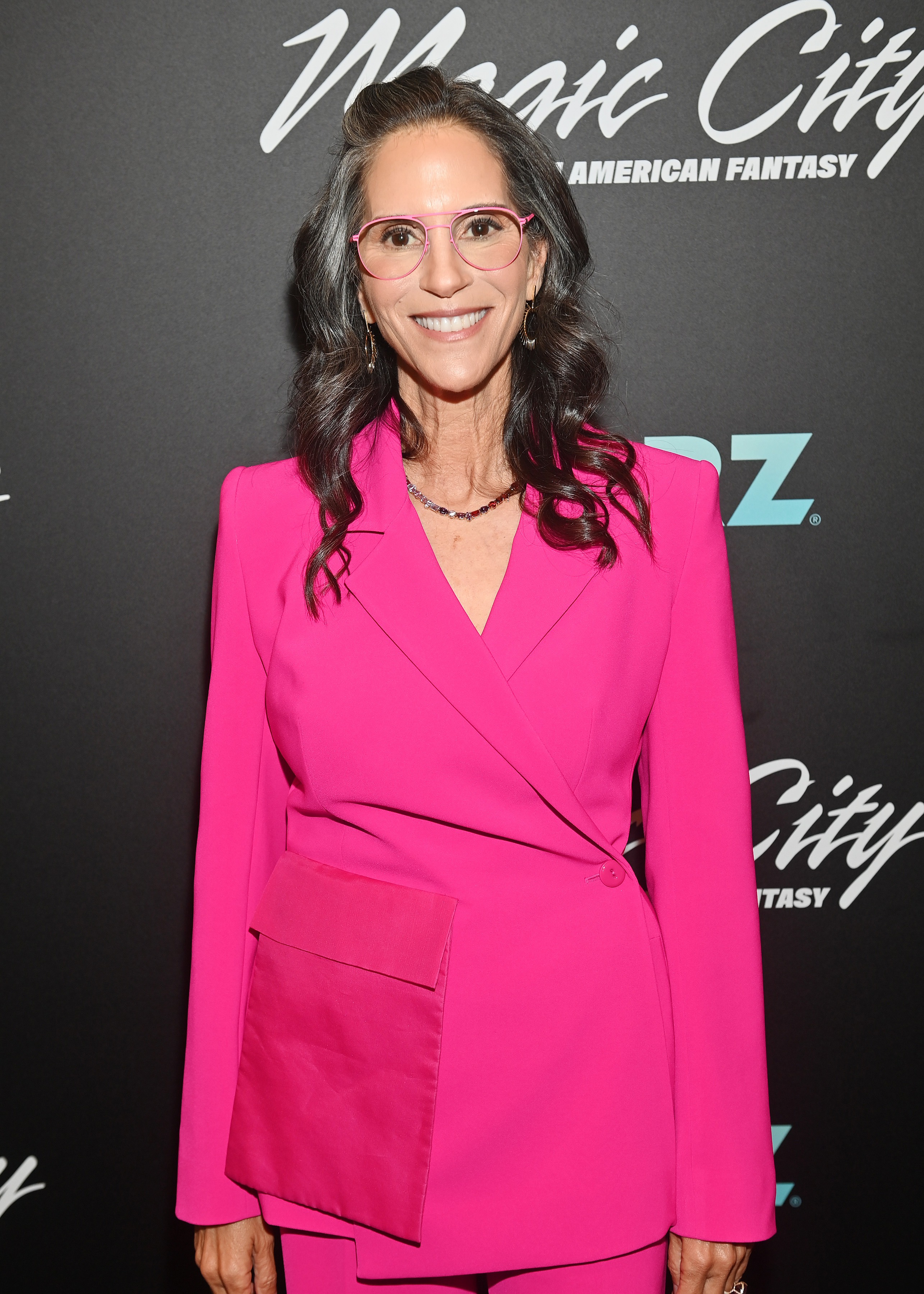Smiling for photographers, Jami Gertz showcased a bold monochromatic pink look at the "Magic City: An American Fantasy" screening.