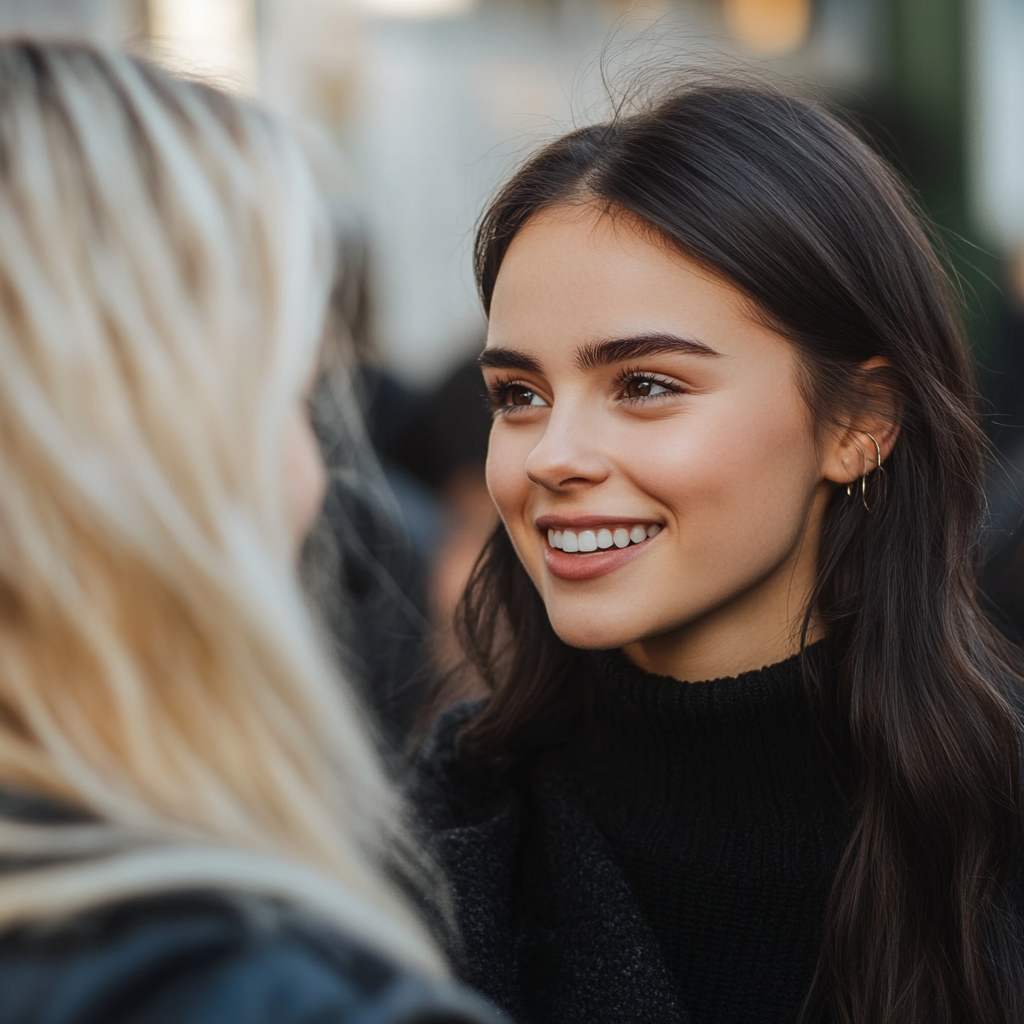 A smiling woman talking to her friend | Source: Midjourney