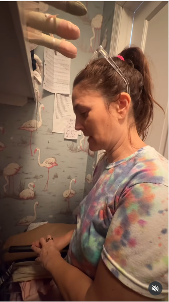 Drew Barrymore taking a break inside a closet from a video posted on July 21, 2025 | Source: Instagram/drewbarrymore