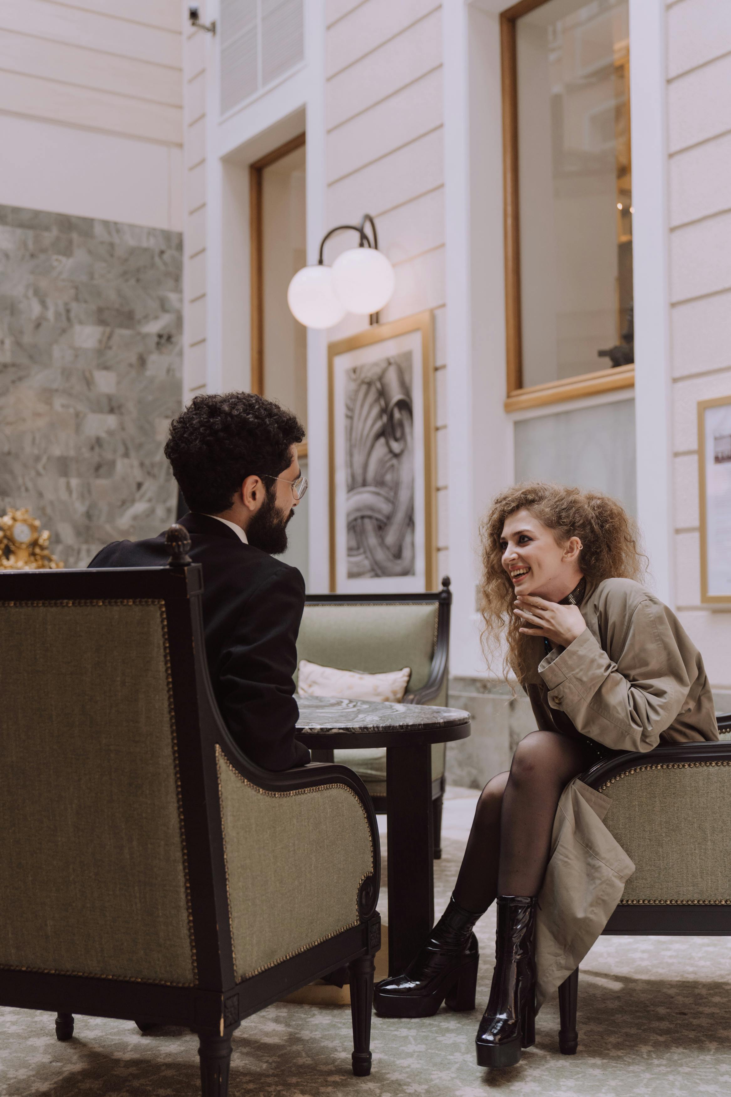 A woman laughing while talking to a man | Source: Pexels