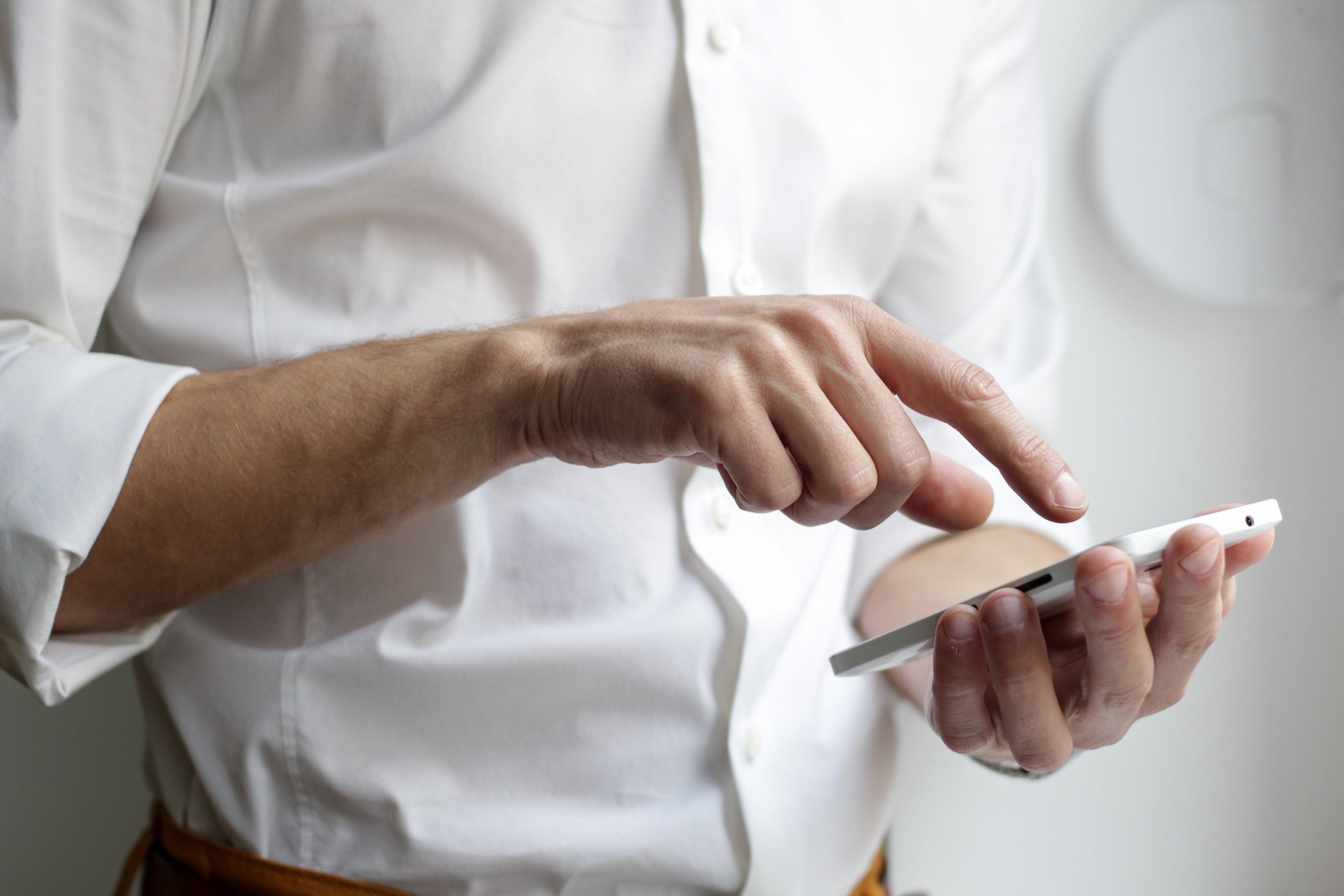 OP checks his wife's phone | Photo: Unsplash