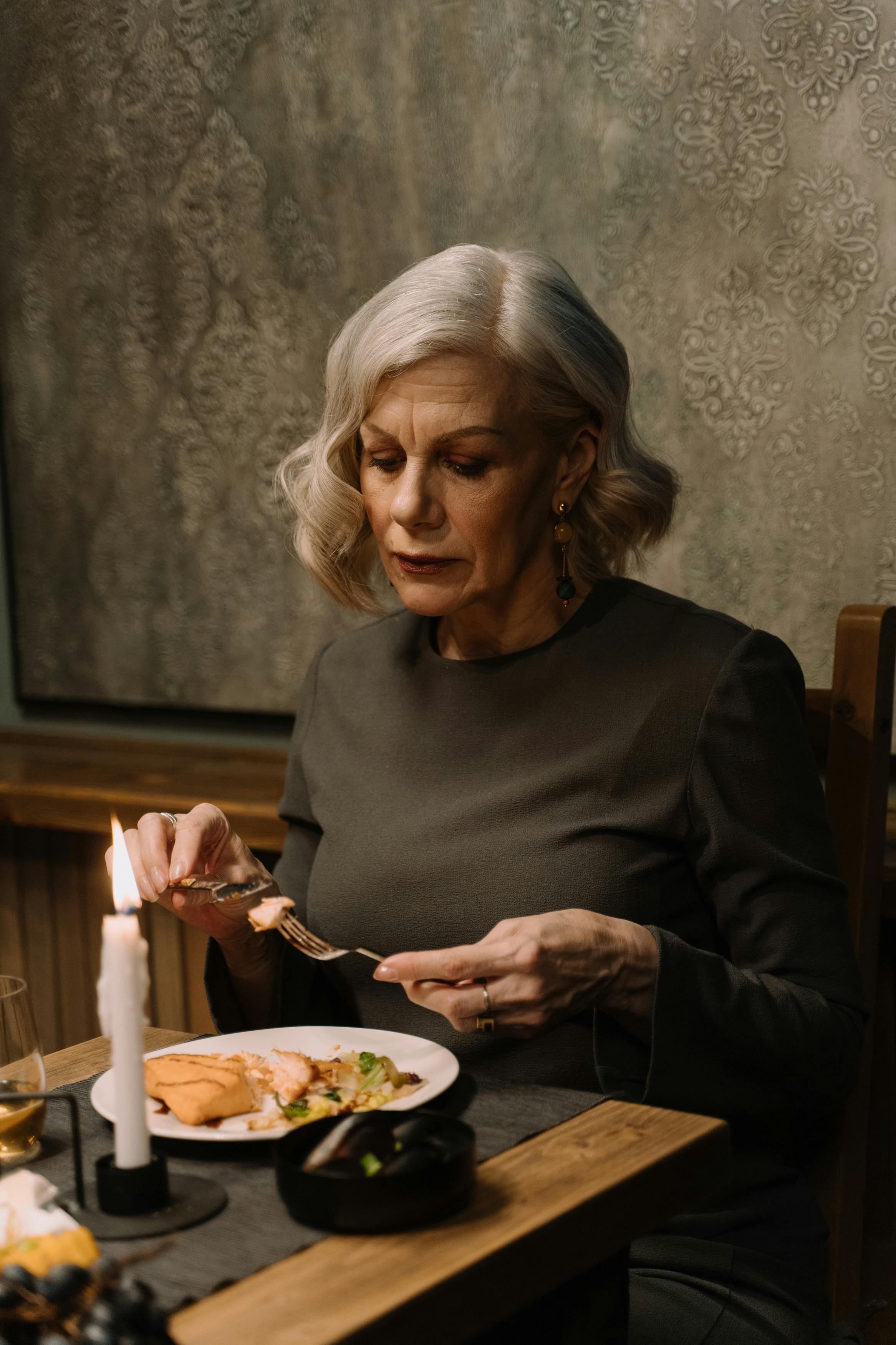 An elderly woman busy eating | Source: Pexels