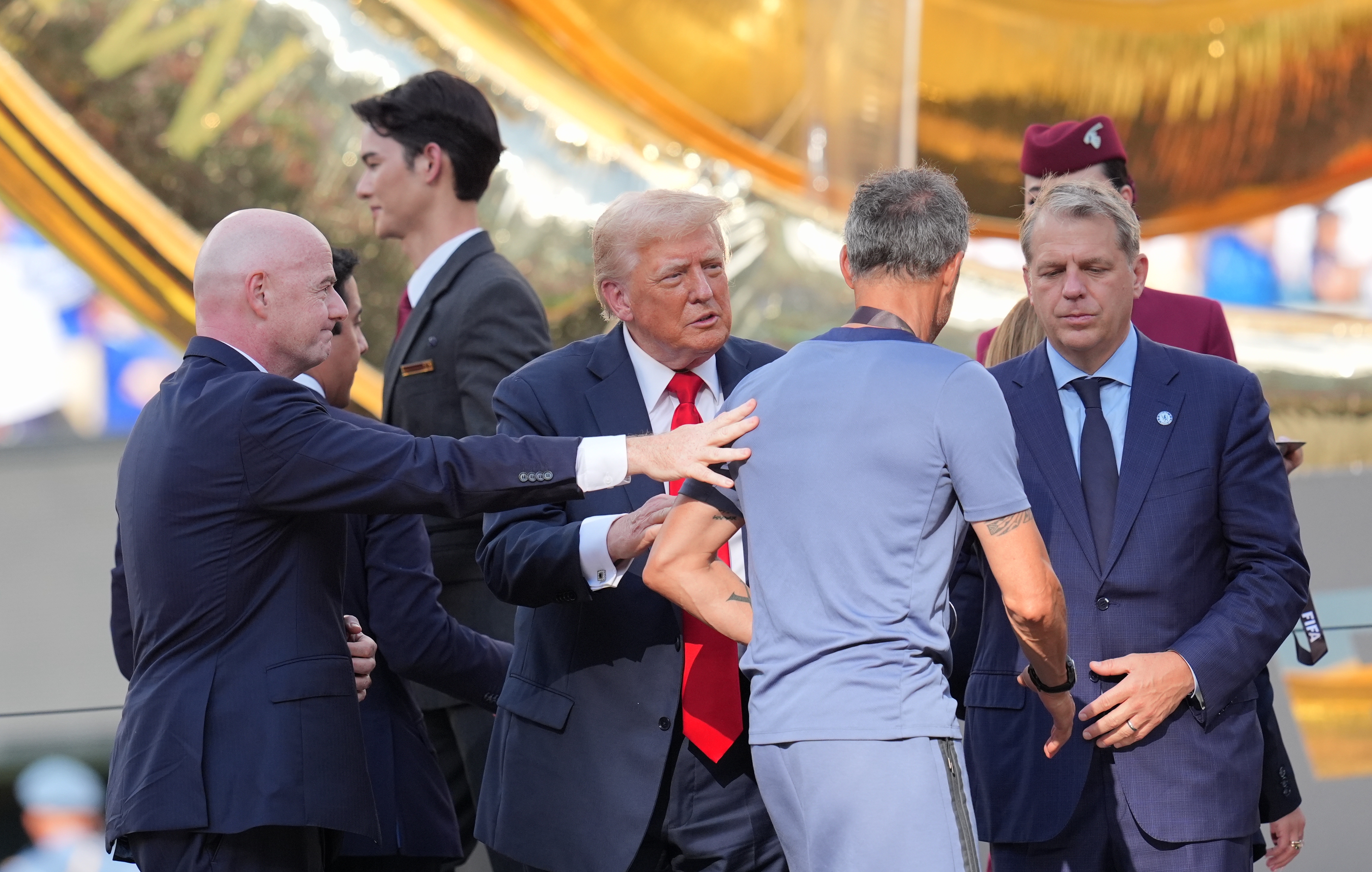 Gianni Infantino and Donald Trump presenting a medal to PSG coach Luis Enrique on July 13, 2025, in New Jersey. | Source: Getty Images