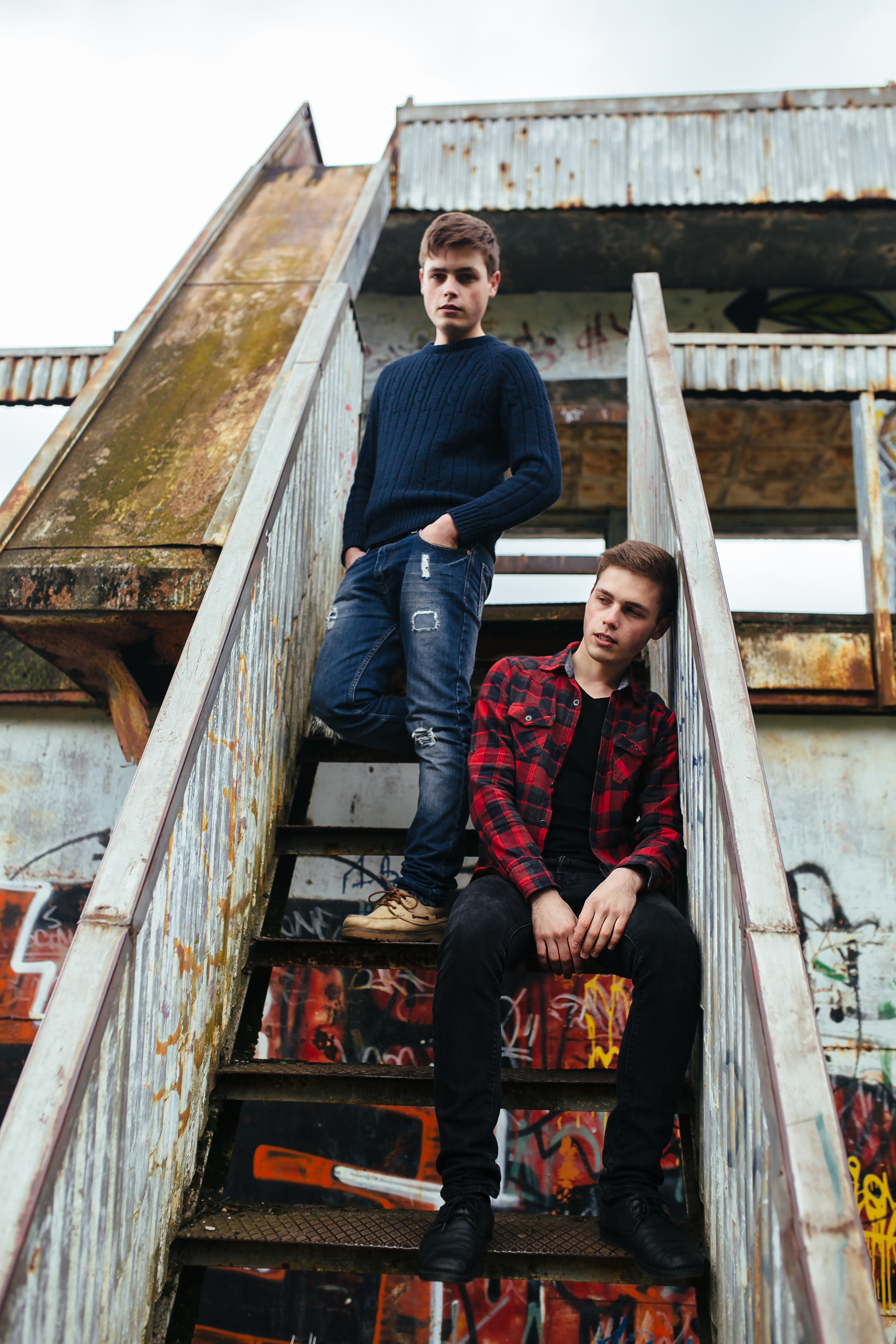Two guys posing on the stairs | Source: Freepik