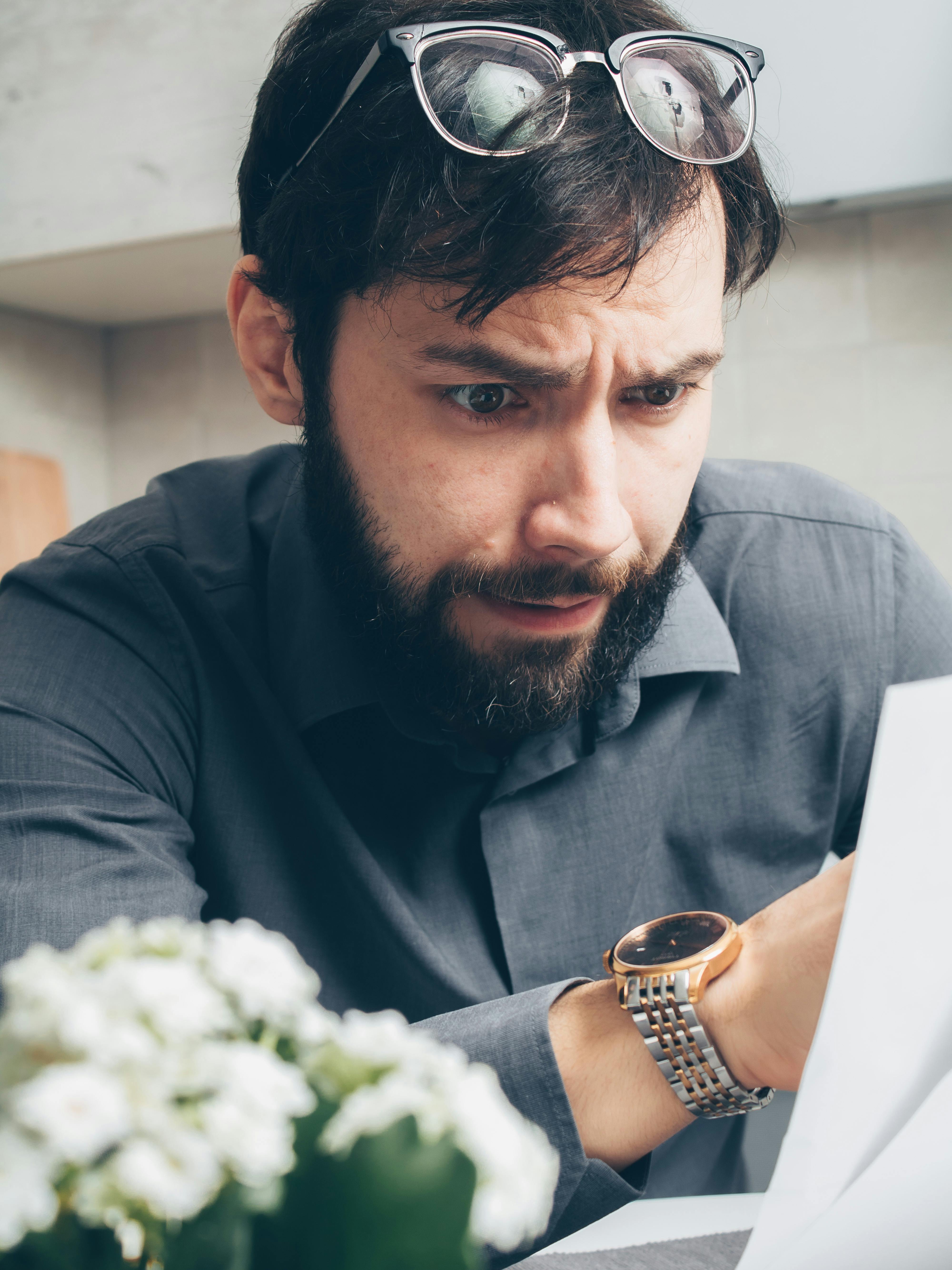 A shocked man looking at some papers | Source: Pexels