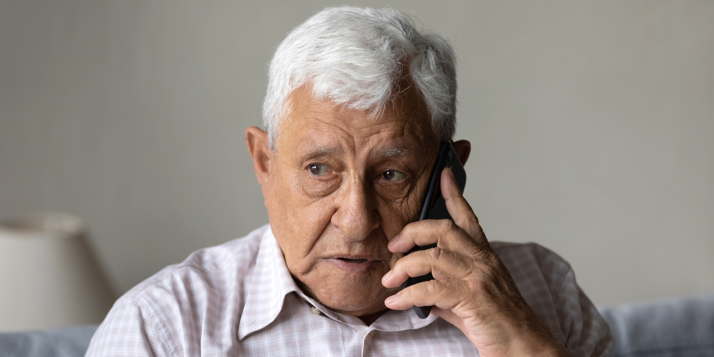 An older man talking on the phone | Source: Shutterstock