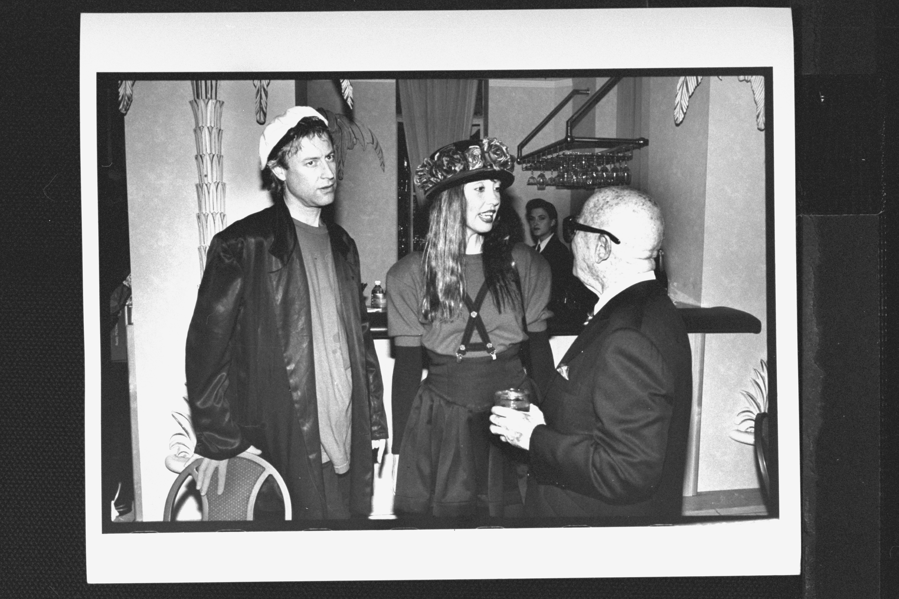 Literary agent Swifty Lazar (R) chatting with actress Shelley Duvall & her boyfriend Dan Gilroy at a party honoring Roddy McDowall's new book of photographs. | Source: Getty Images
