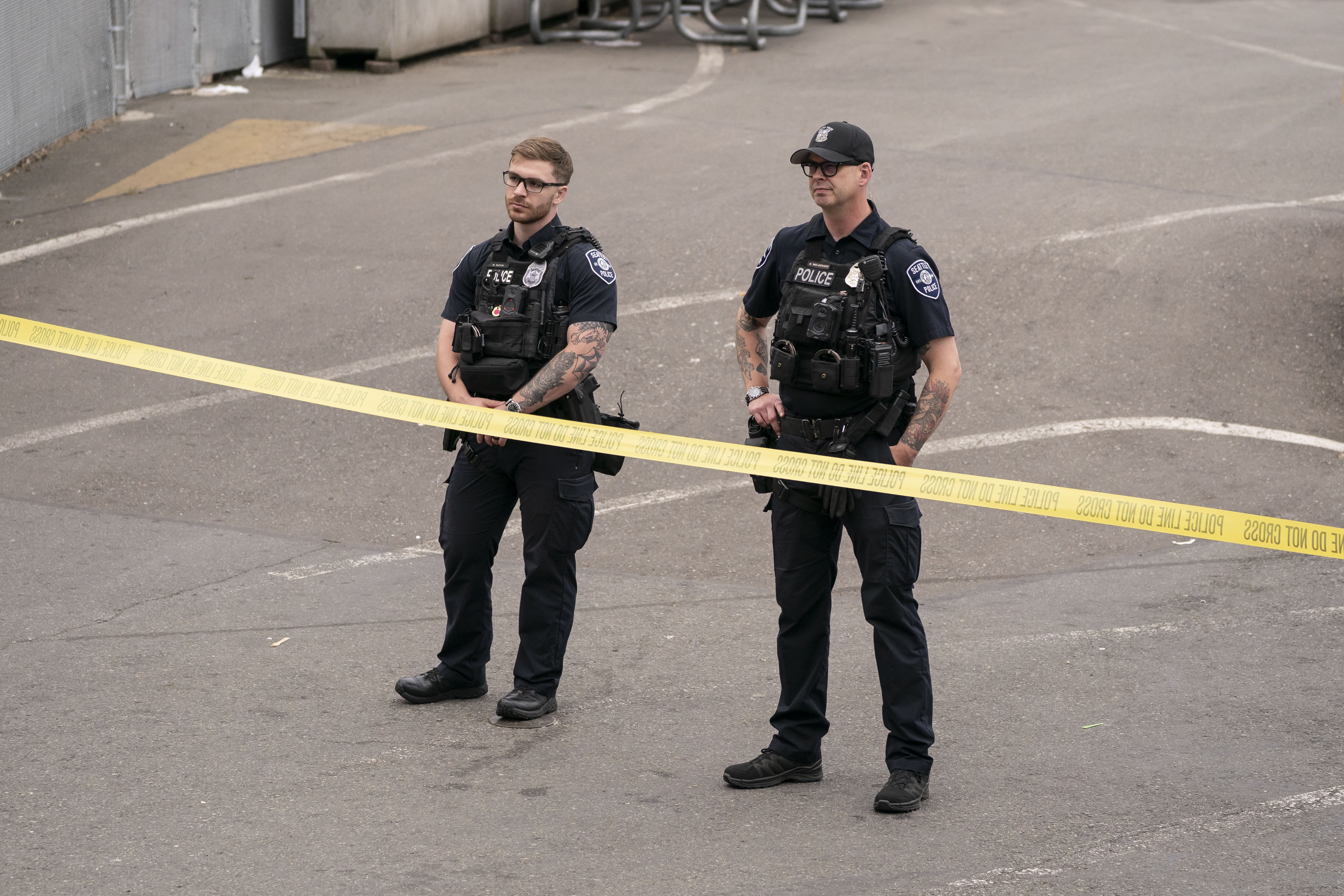 Police officers stand behind crime scene tape after the deadly shooting at Seattle Center during the Bite of Seattle festival. | Source: Getty Images