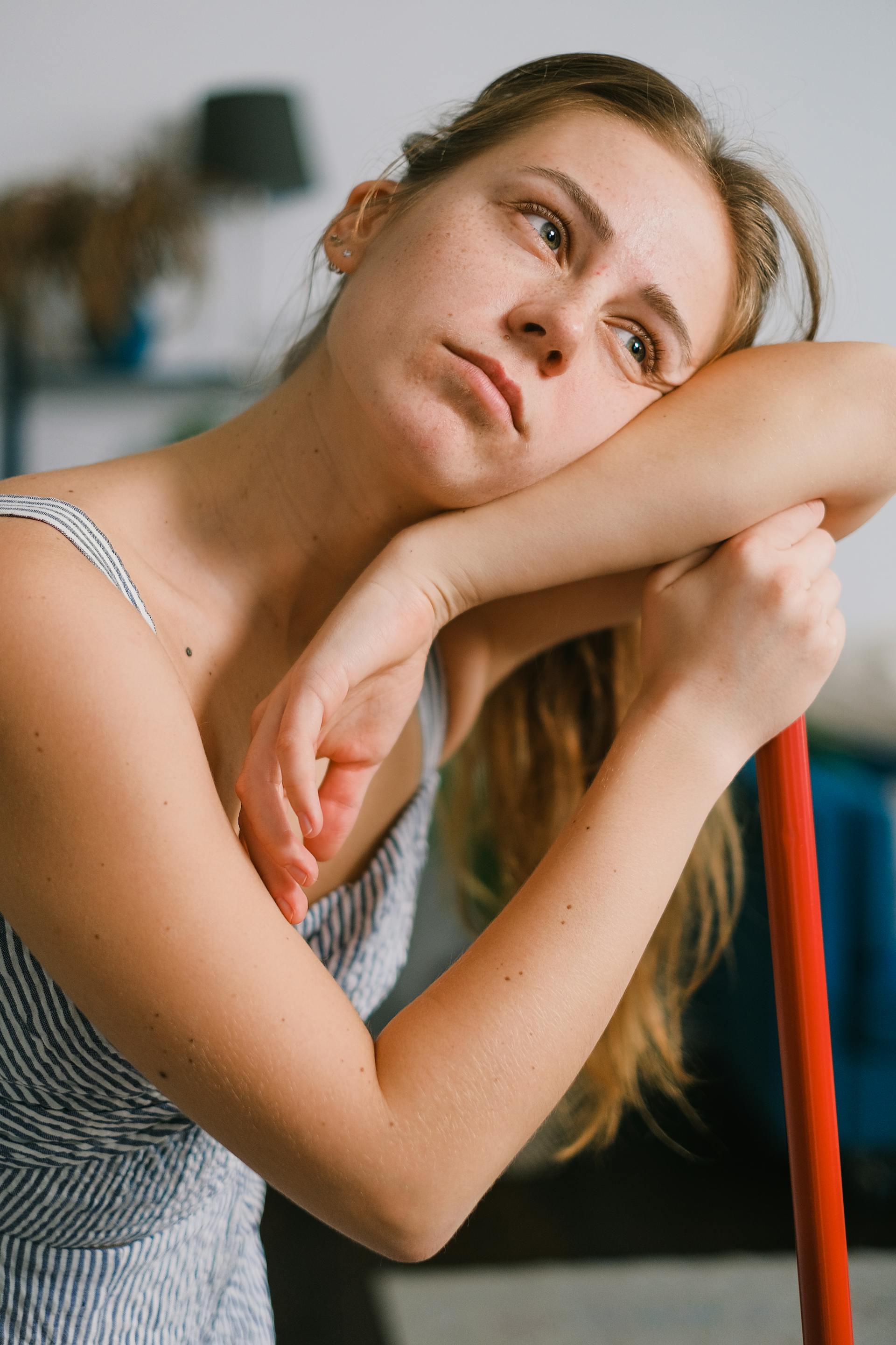 A woman leaning on a broom | Source: Pexels