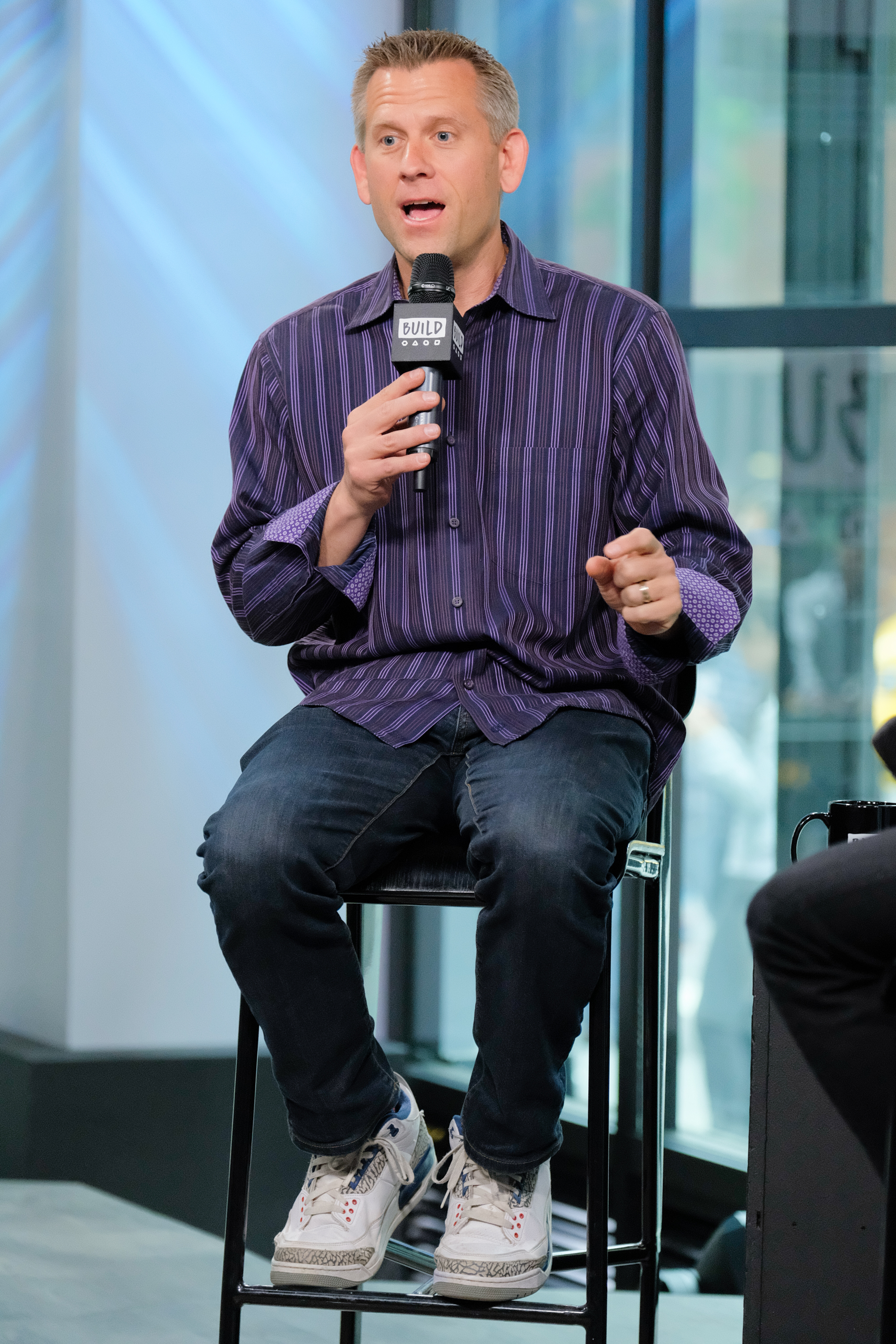 John Brenkus talks about his podcast "Brink Of Midnight" on June 5, 2017, in New York City | Source: Getty Images