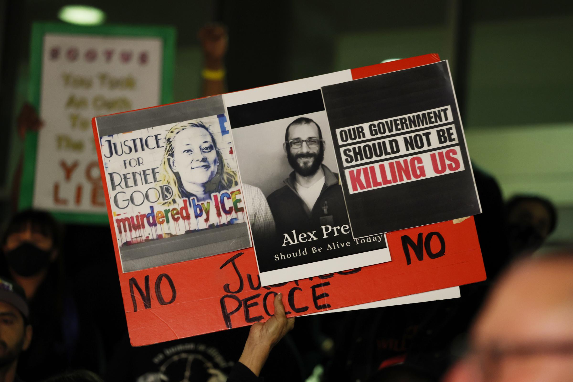 A protester holds a sign for Renee Good and Alex Pretti at a candlelight vigil in Los Angeles on January 24, 2026 | Source: Getty Images