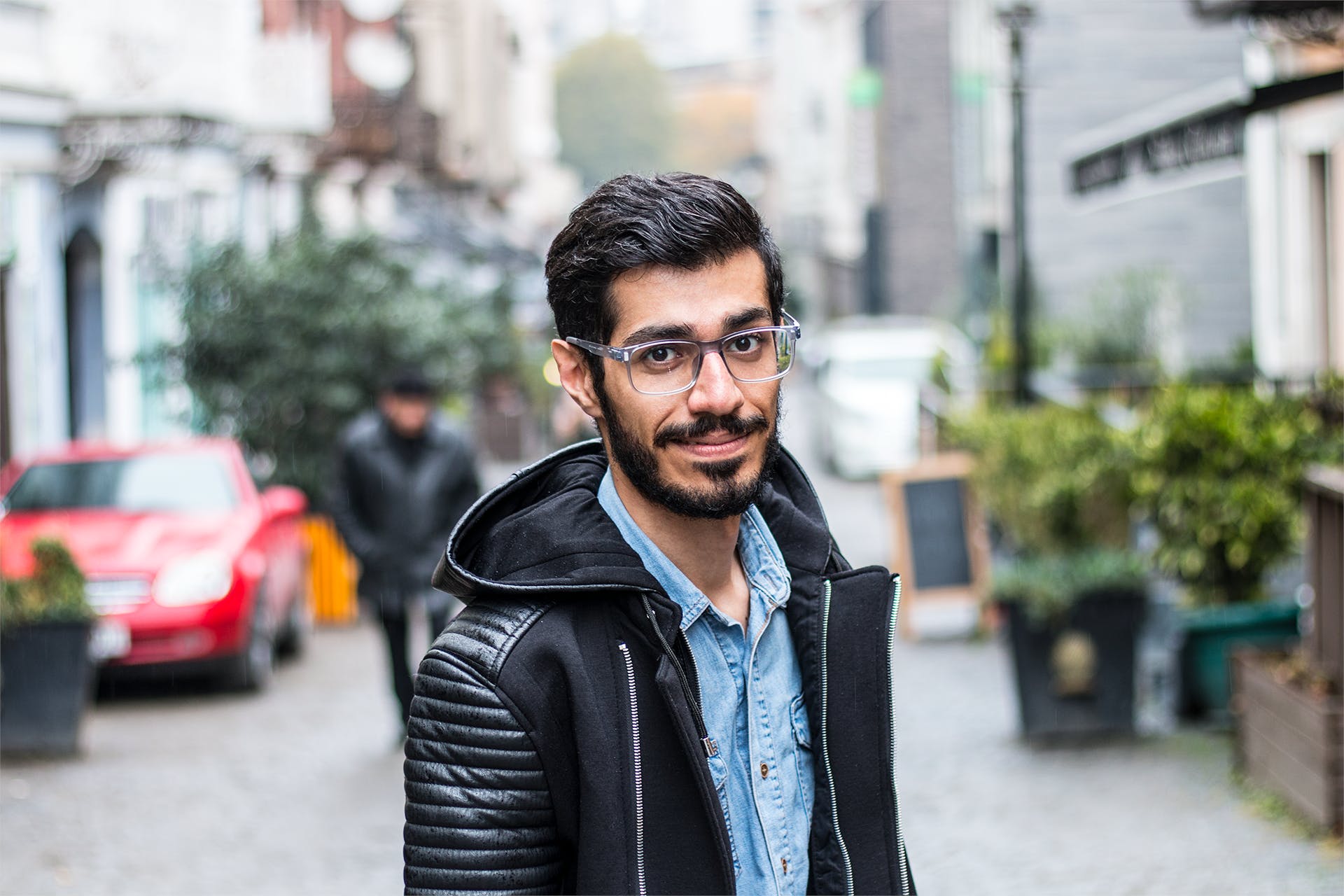 A man wearing glasses while walking on a street | Source: Pexels
