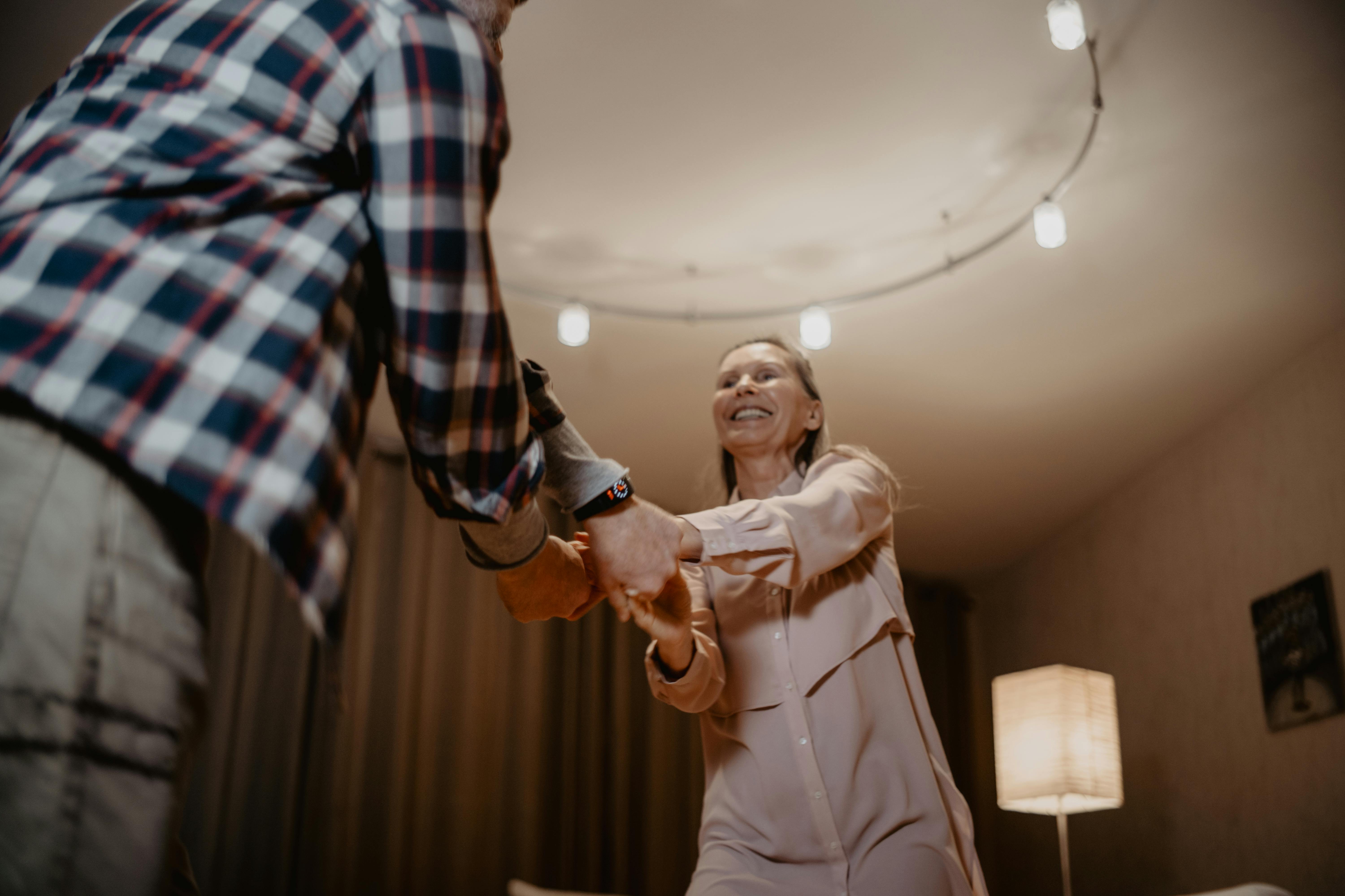 A couple dancing together in the living room | Source: Pexels
