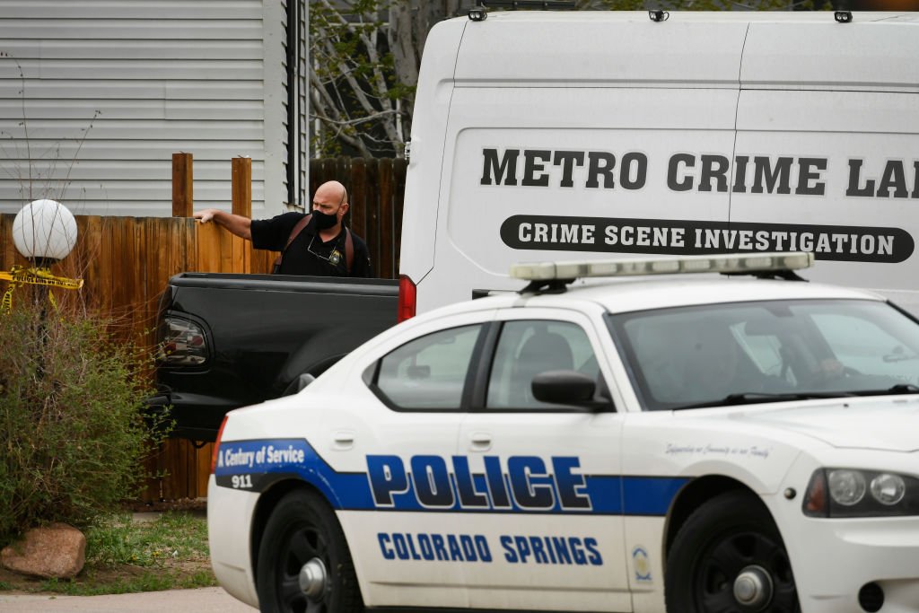 A Colorado Springs police investigator exits the home where an overnight shooting occurred in the Canterbury Mobile Home Park on May 9, 2021 | Photo: Getty Images