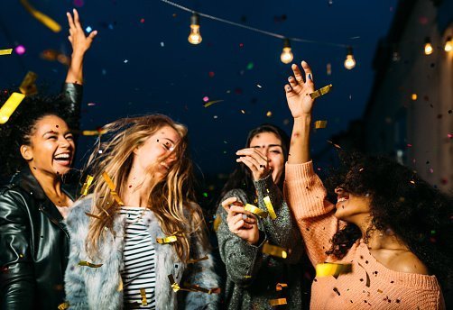 Young female friends pictured  enjoying a party at night | Photo: Getty Images