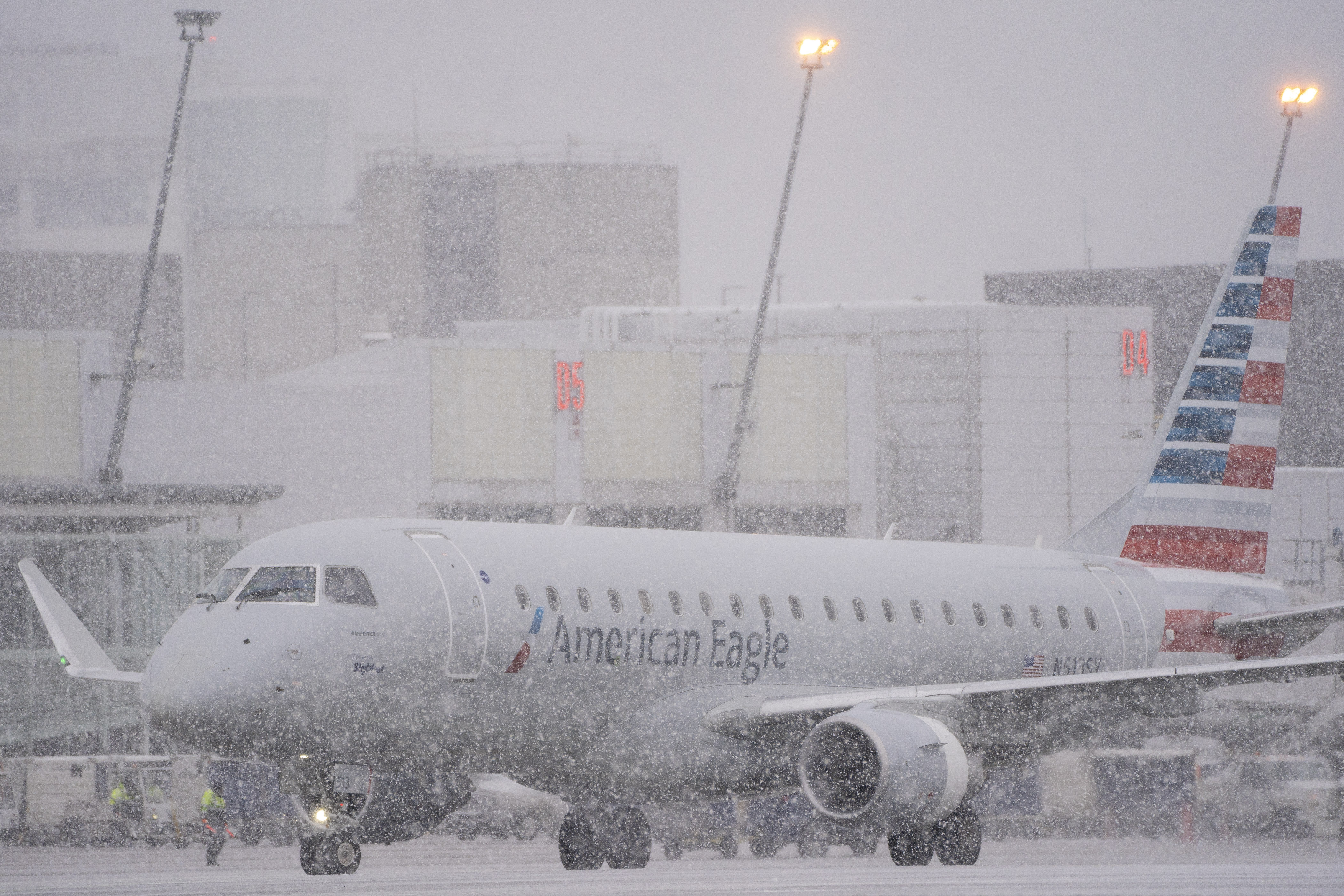 An American Eagle plane taxis during a snow storm at Seattle-Tacoma International Airport (SEA) in Seattle, Washington, on December 20, 2022 | Source: Getty Images