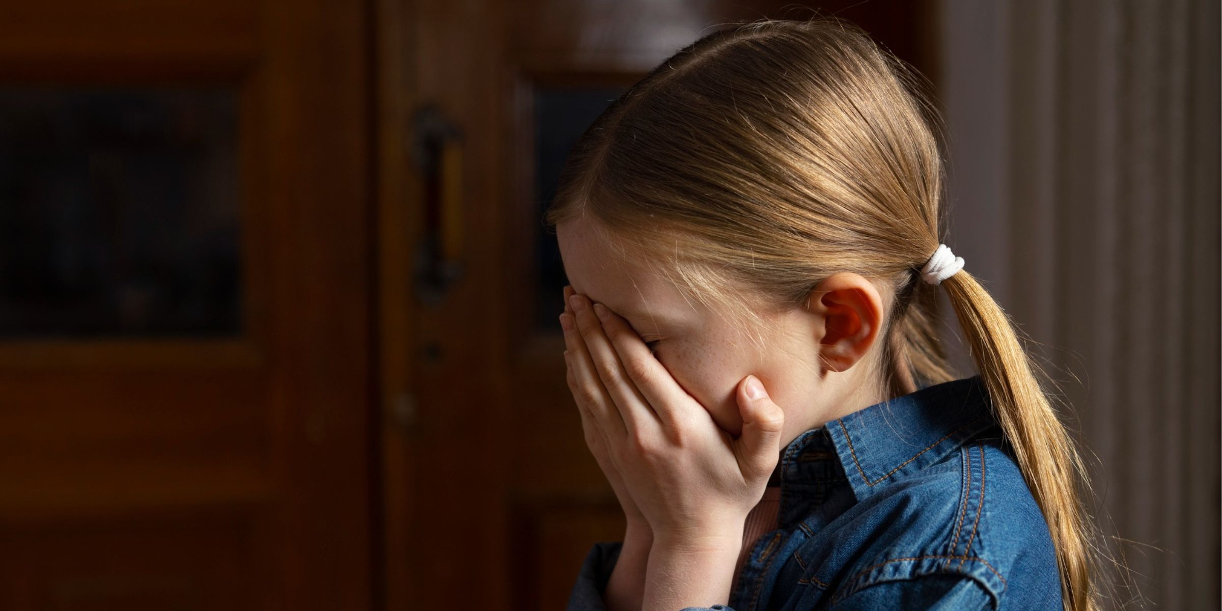A girl burying her face in her hands | Source: Freepik
