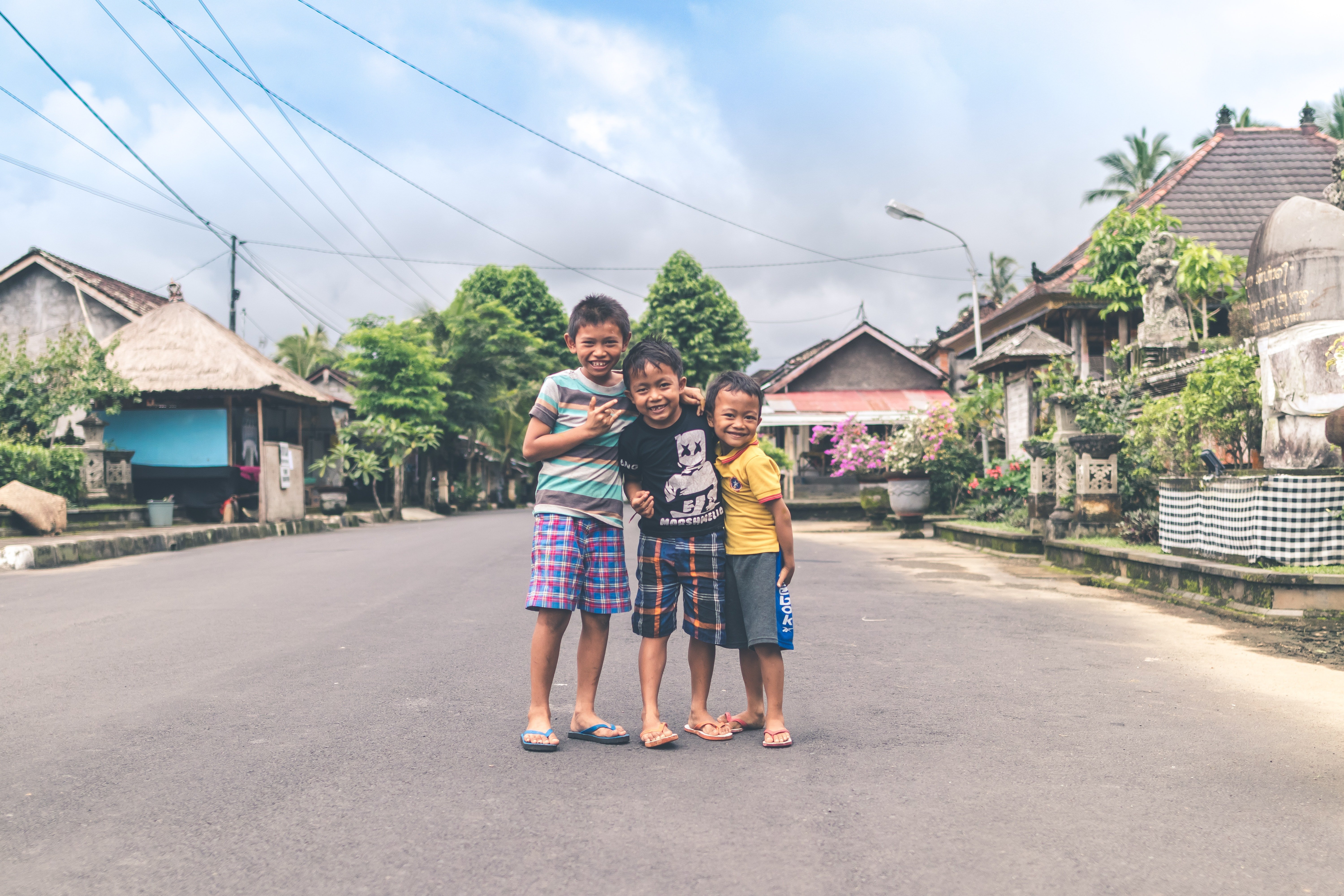 Pictured - Three young boys posing for a photo on the road | Source: Pexels 