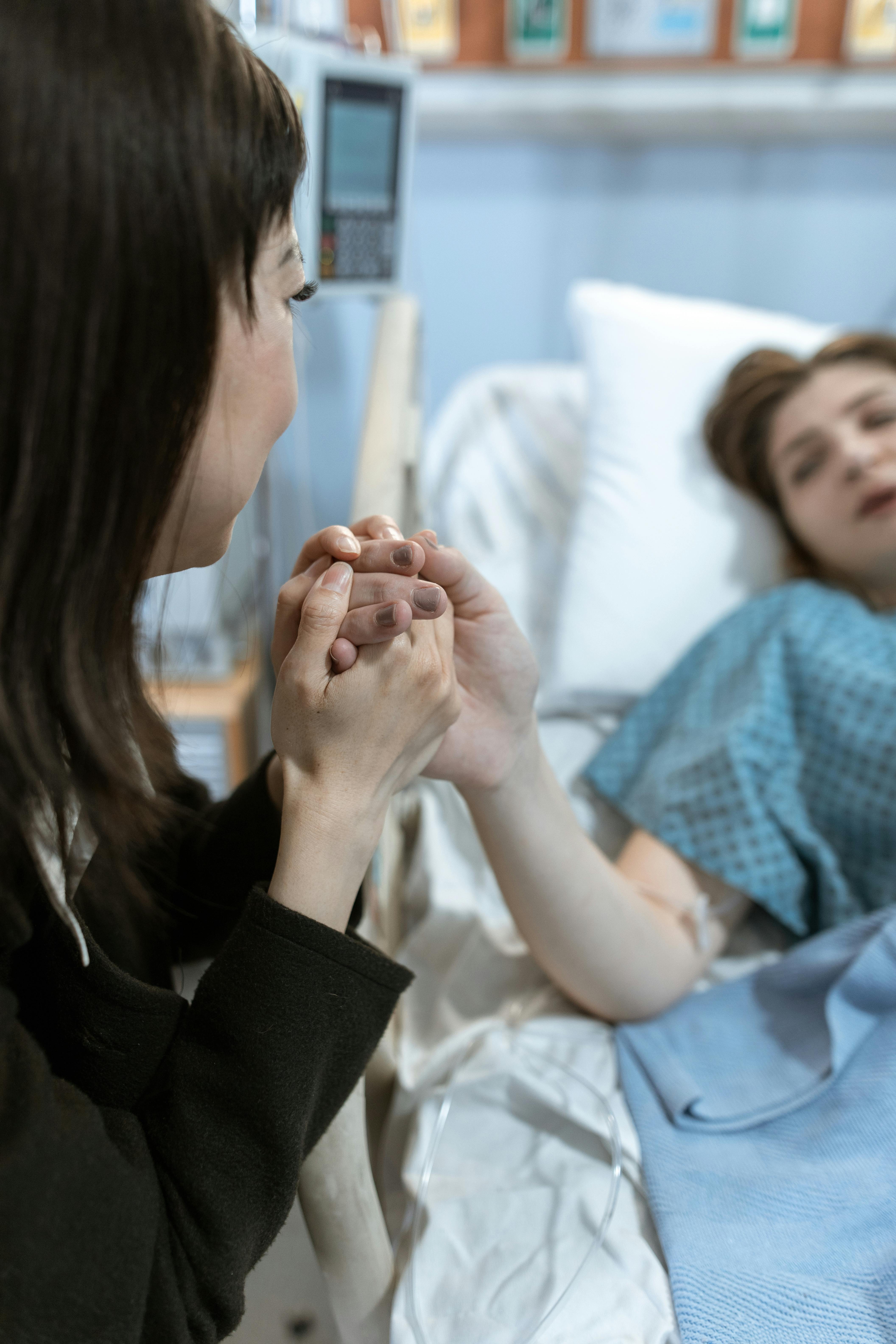 Woman holding sick womans hand | Source: Pexels