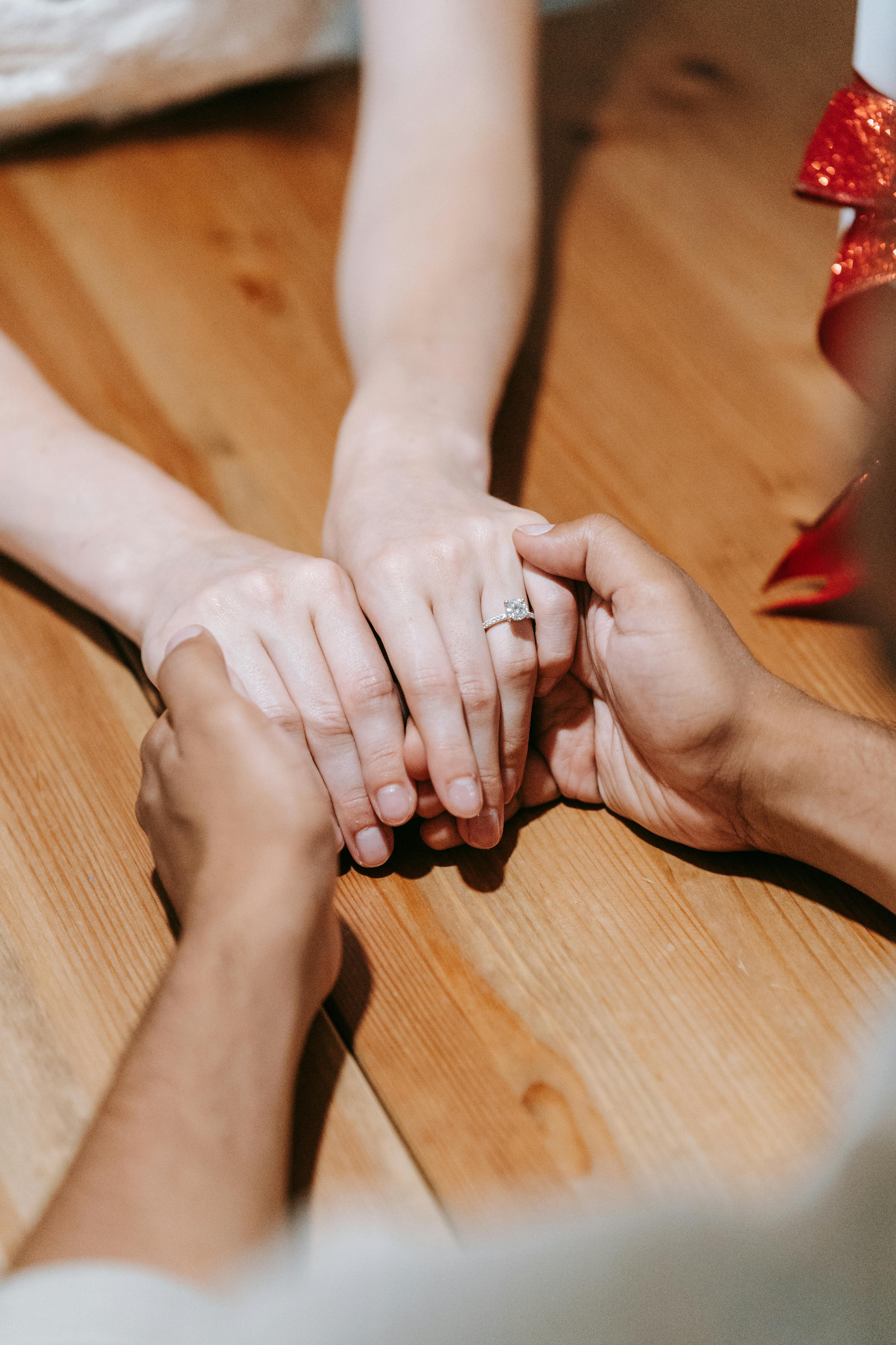 A couple holding hands after a proposal | Source: Pexels