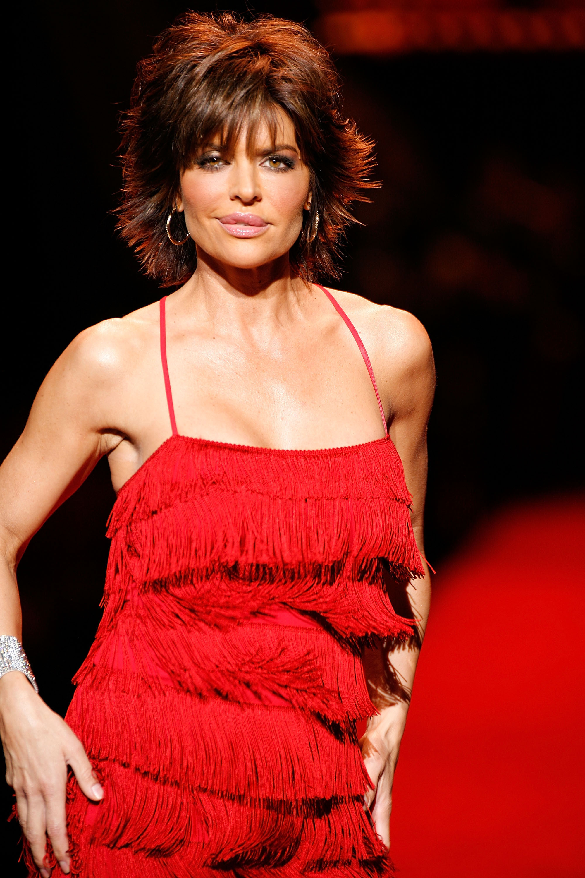 Lisa Rinna walks the runway at the Heart Truth Red Dress Collection fashion show during Mercedes-Benz Fashion Week Fall at Bryant Park on February 1, 2008, in New York City.