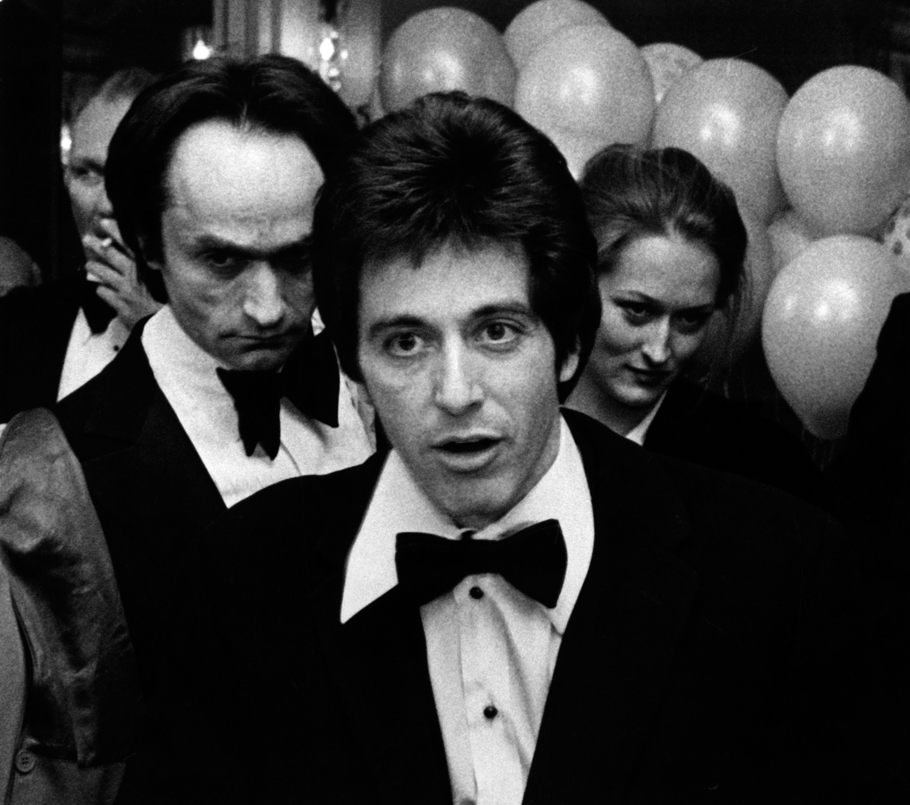 John Cazale and Meryl Streep behind Al Pacino at the 75th Birthday Party for Lee Strasberg on November 29, 1976 | Source: Getty Images