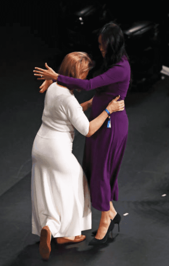 During the One Young World Summit Opening Ceremony, Meghan Meghan awkwardly hugs the event founder, Kate Robertson on stage, at Royal Albert Hall, on October 22, 2019, in London, England | Source: Gareth Fuller - Pool/Getty Images