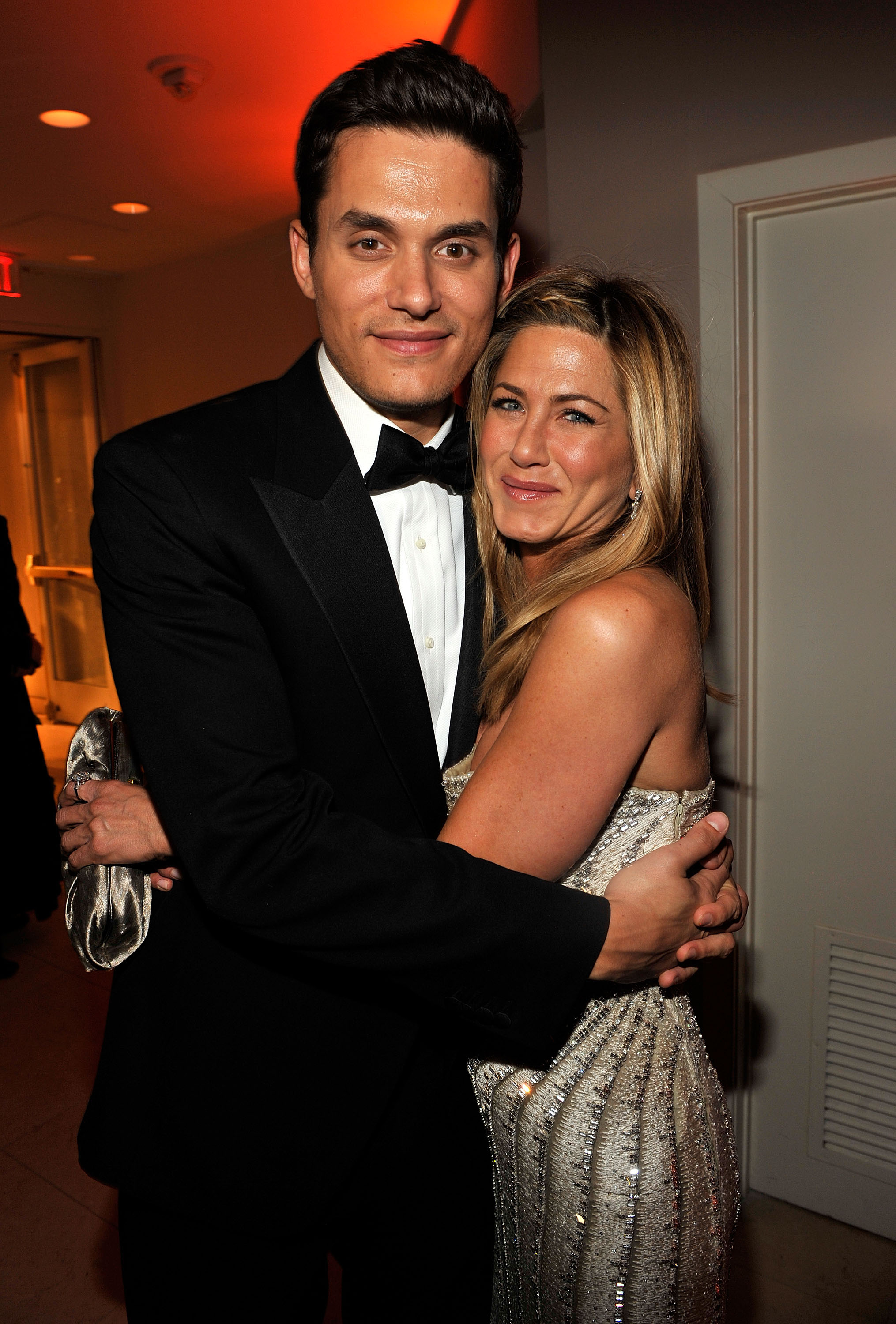 Later that night at the Vanity Fair Oscar Party, Jennifer Aniston was photographed embracing John Mayer. The pair smiled as they posed closely together indoors.