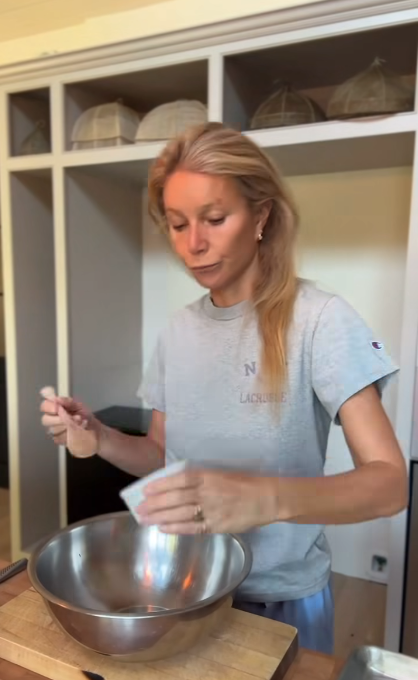 Gwyneth Paltrow adding ingredients to a mixing bowl on her video, dated July 19, 2025 | Source: Instagram/gwynethpaltrow