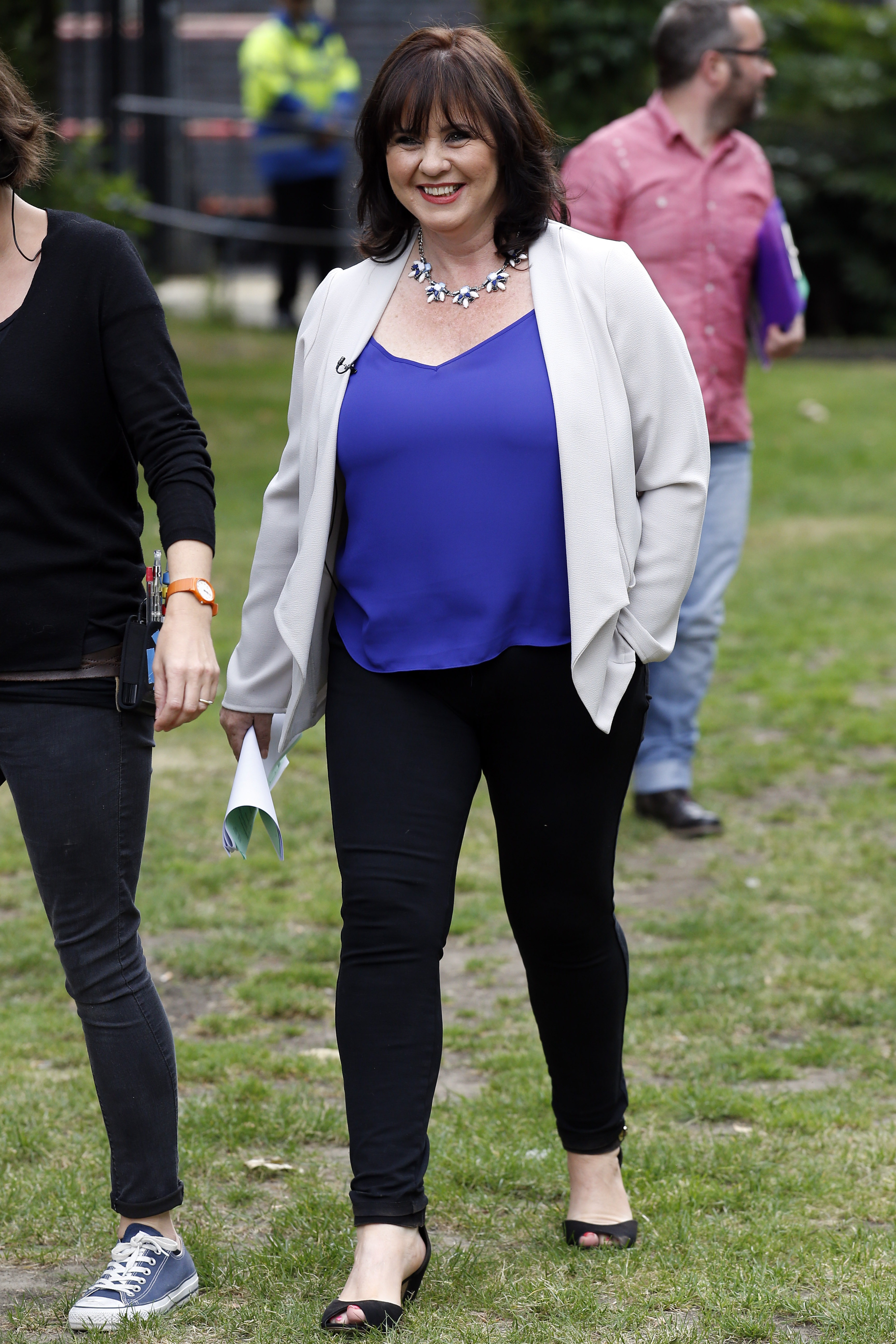 Nolan chanelled chic vibes on the Southbank during "Loose Women" filming in London on 8 July 2014. She brightened the setting in a cobalt camisole beneath a dove-grey jacket and black trousers. Open-toe heels, a floral necklace, and a warm smile finished the look.