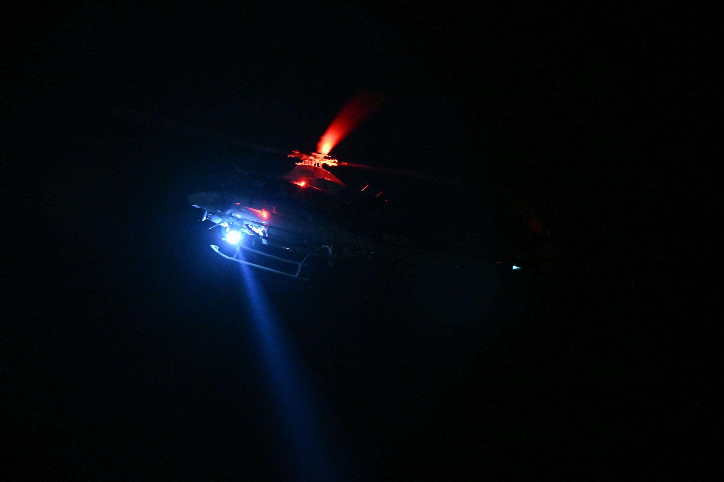 A helicopter flying over the incident scene. | Source: Getty Images