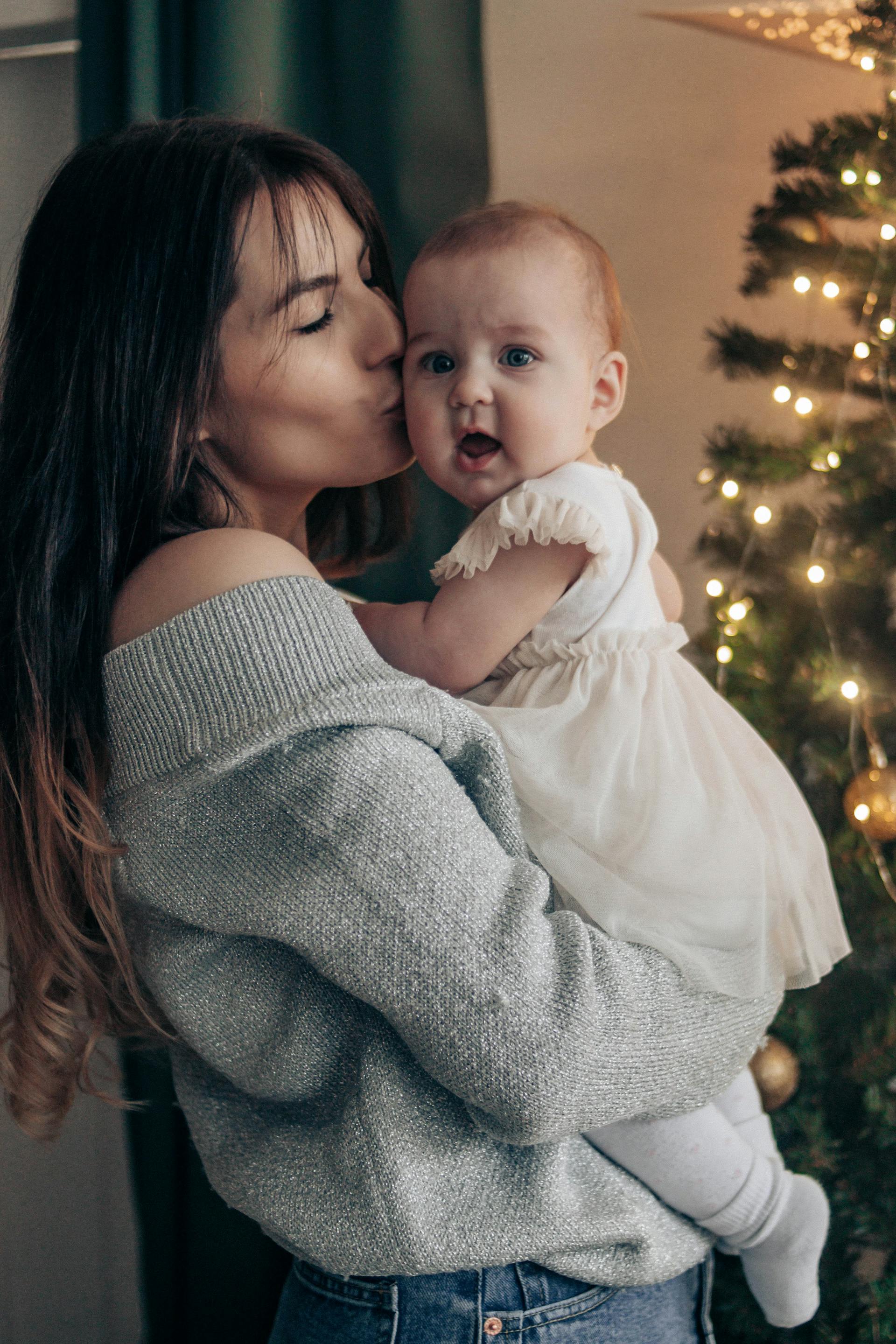 A mother kissing her little daughter | Source: Pexels