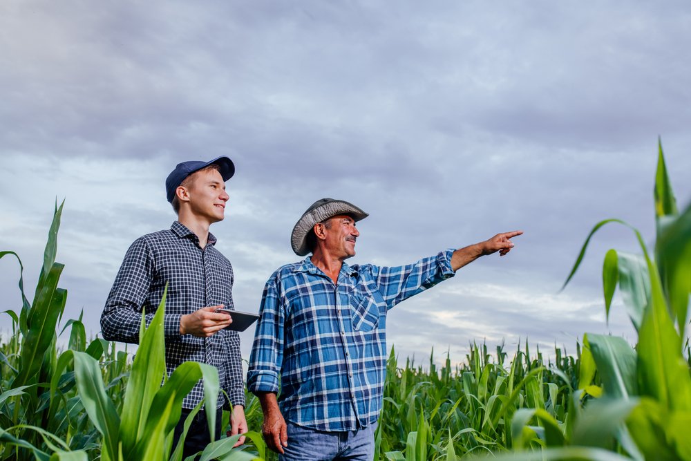 Two farmers discussing the size of their farms | Shutterstock