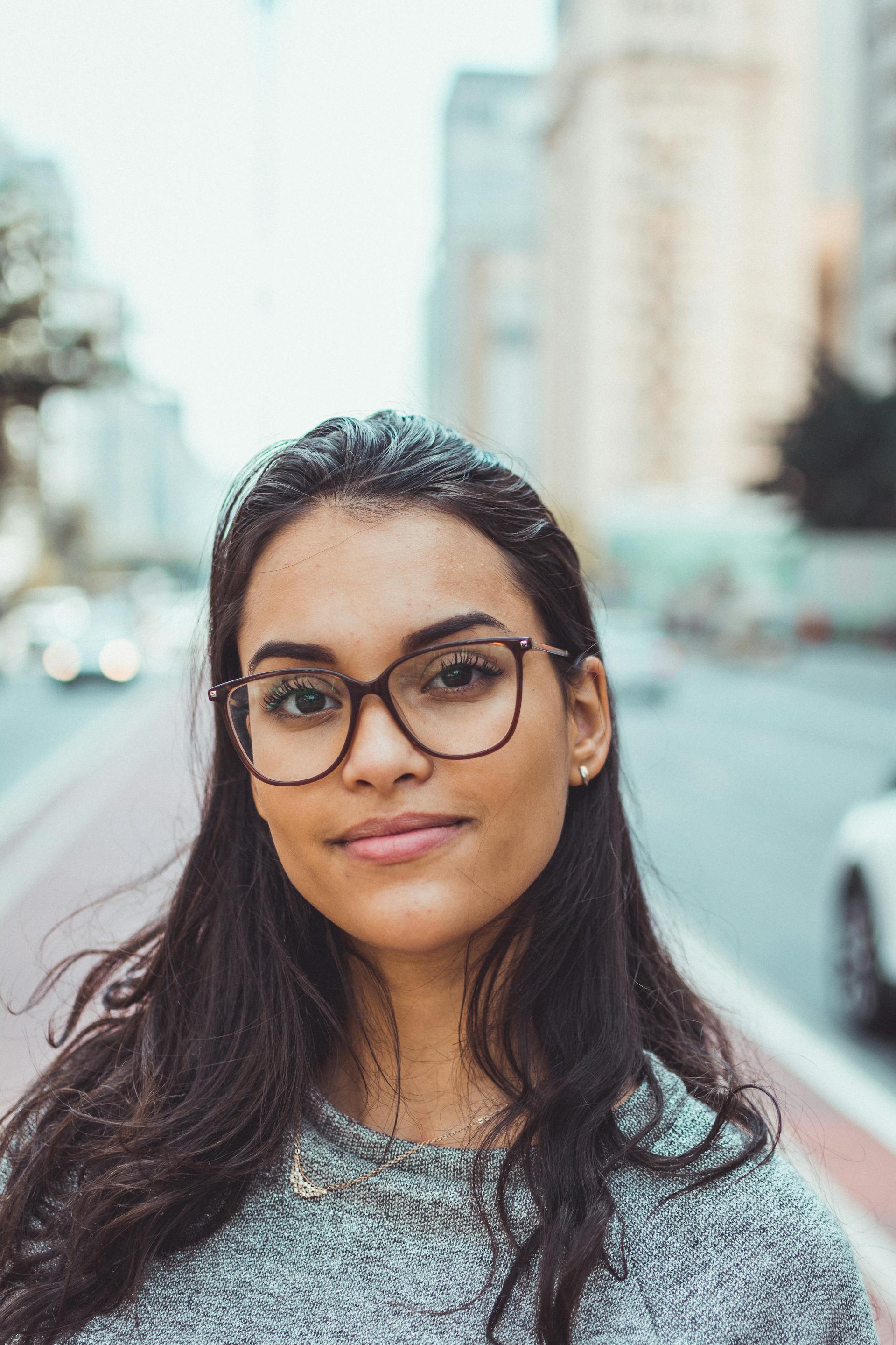 A person wearing framed eyeglasses standing on the road | Source: Pexels