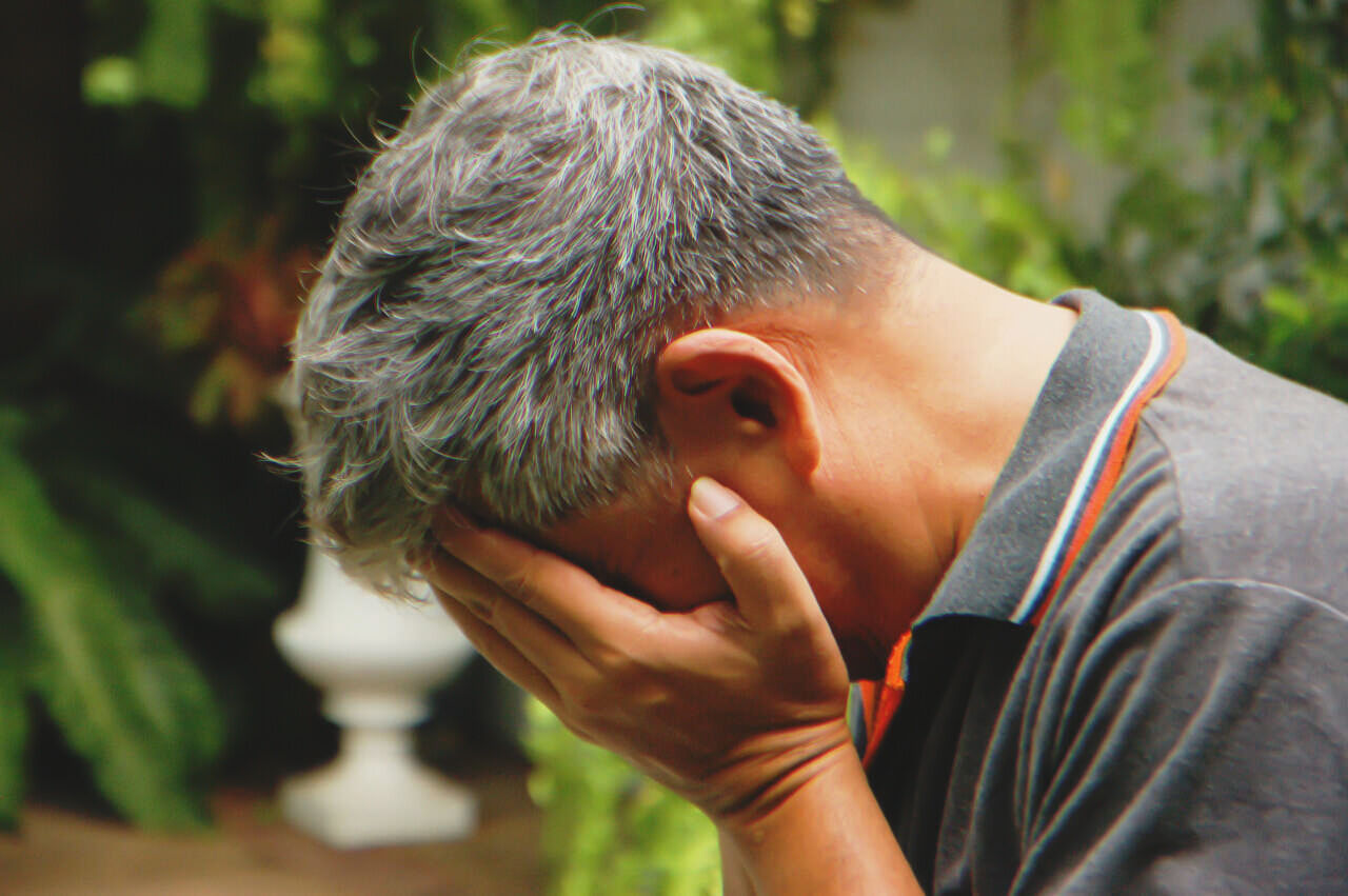 A middle-aged man crying | Source: Shutterstock
