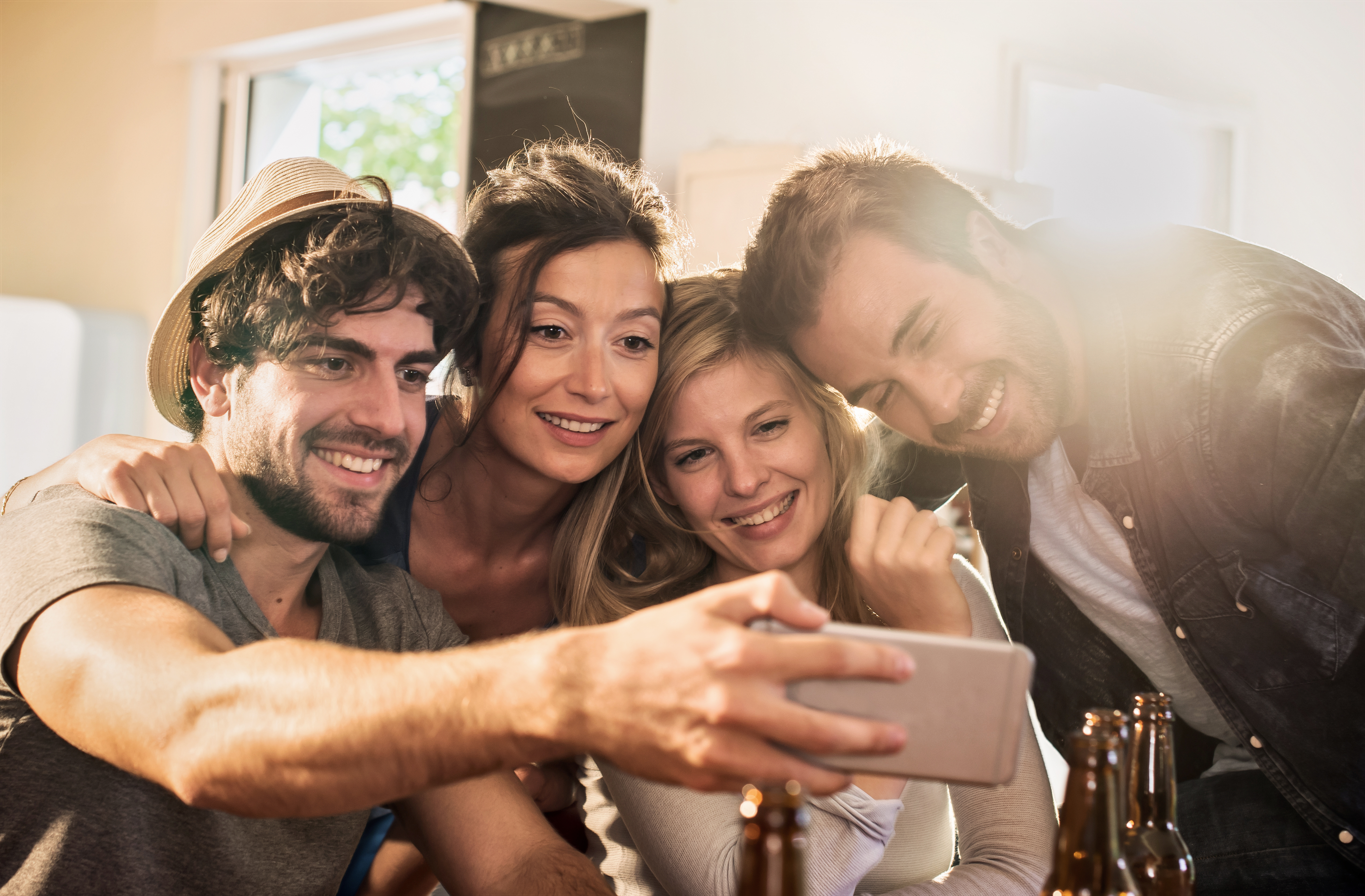 Friends taking a selfie on a smartphone | Source: Shutterstock