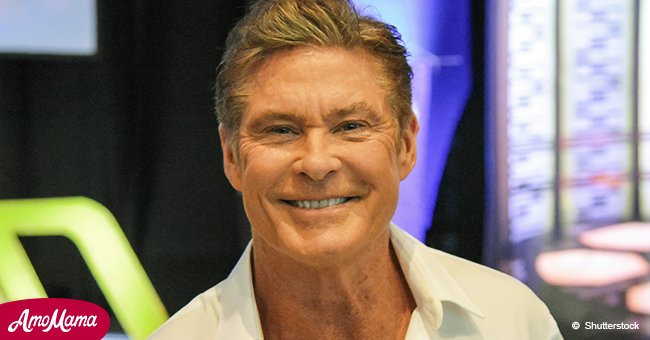 David Hasselhoff, 65, flaunts his muscular biceps as he goes shirtless while taking a stroll