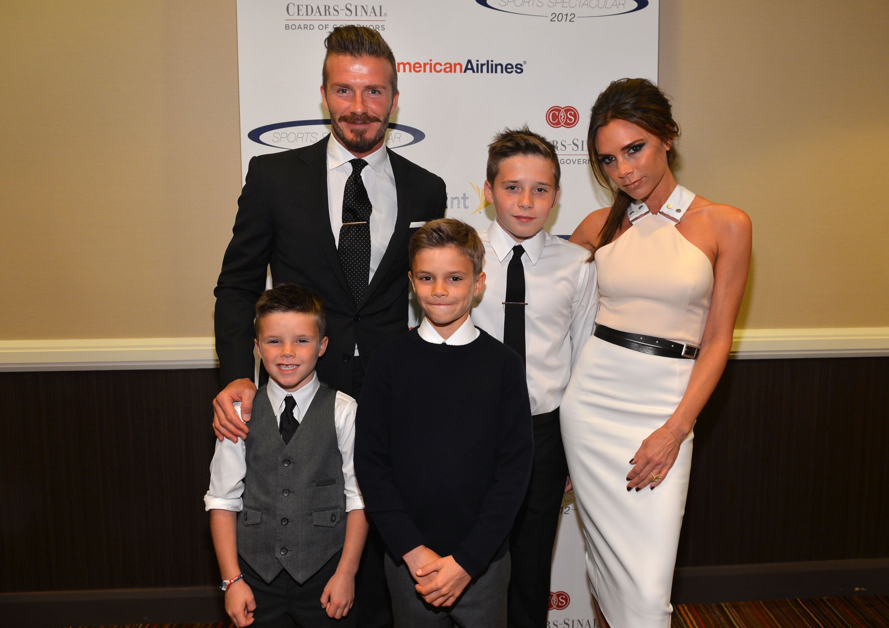 David Beckham, Victoria Beckham and their sons Cruz, Romeo and Brooklyn Beckham during the 27th Anniversary Sports Spectacular benefiting Cedars-Sinai Medical Genetics Institute at the Hyatt Regency Century Plaza on May 20, 2012 in Century City, California. | Source: Getty Images
