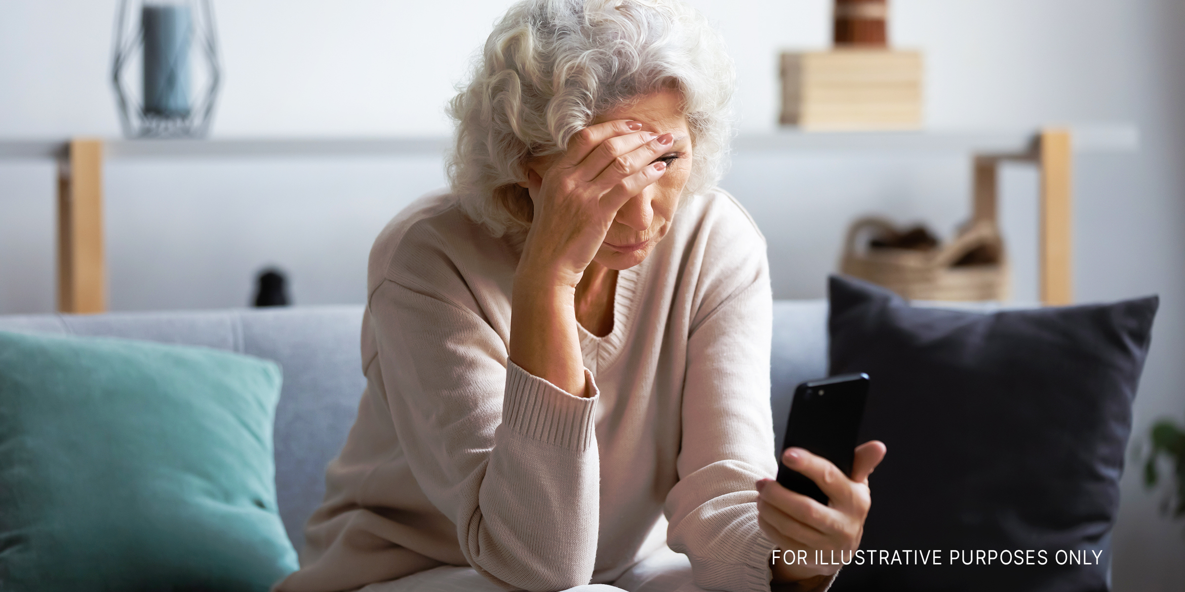 An unhappy senior woman looking at her phone screen | Source: Shutterstock