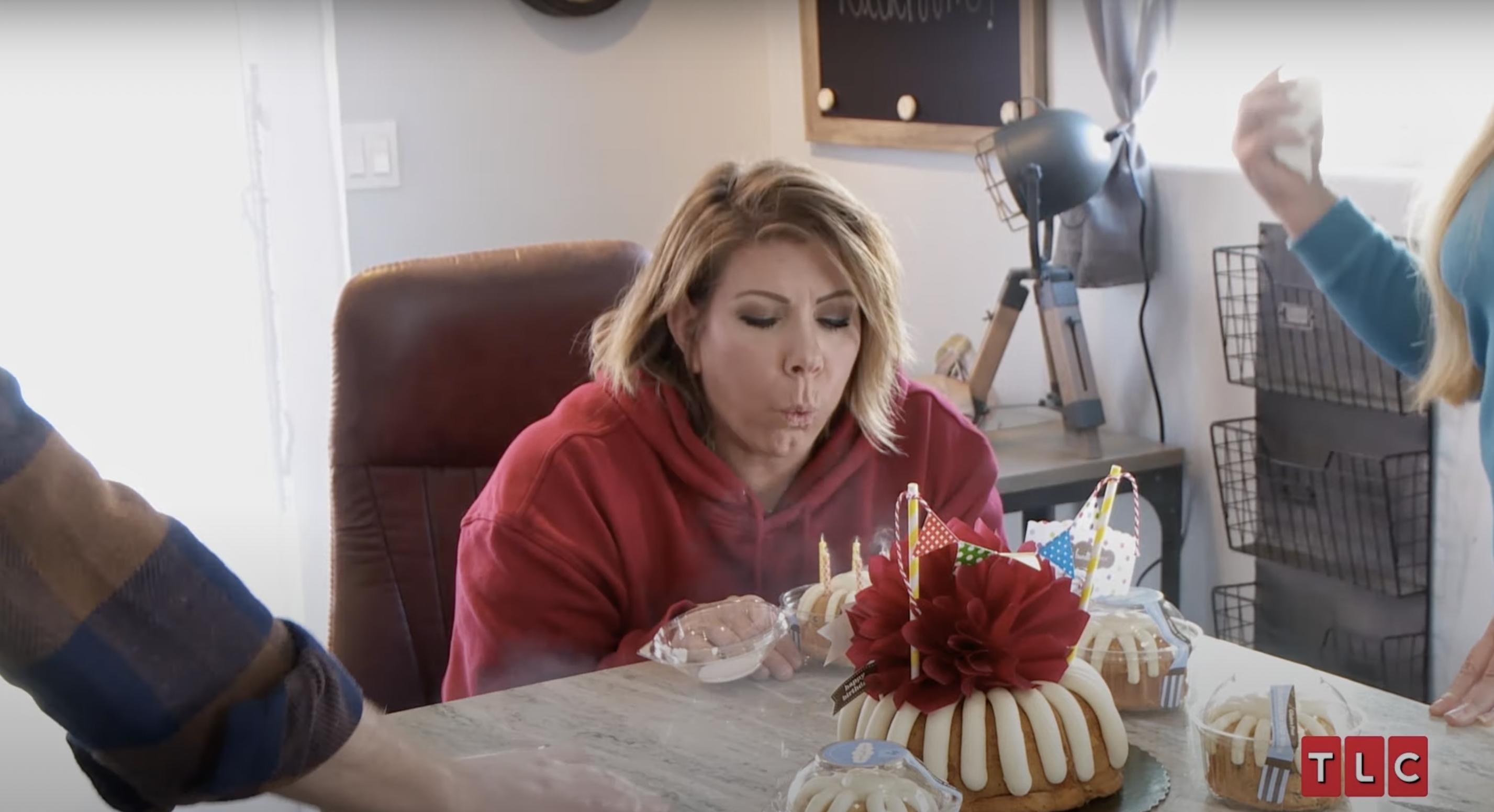 Meri Brown blowing out candles on a cake during an episode of "Sister Wives" | Source: YouTube/TLC