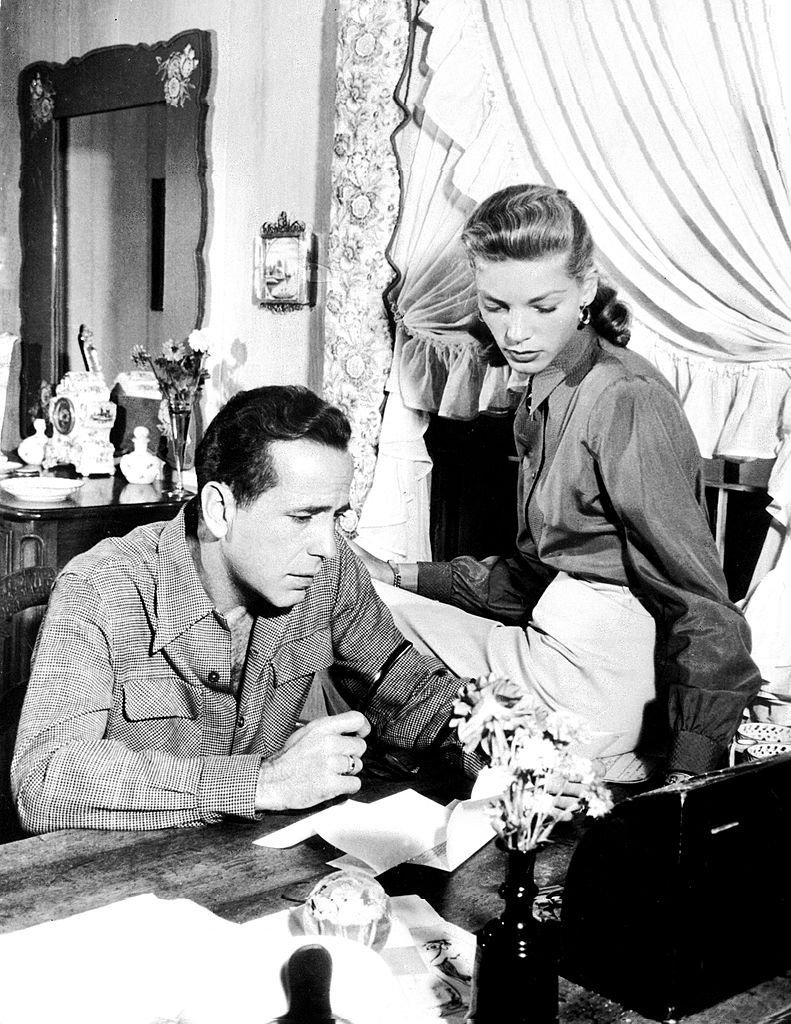 Humphrey Bogart and Lauren Bacall in a black-and-white image in 1948. | Source: CORR/AFP/GettyImages