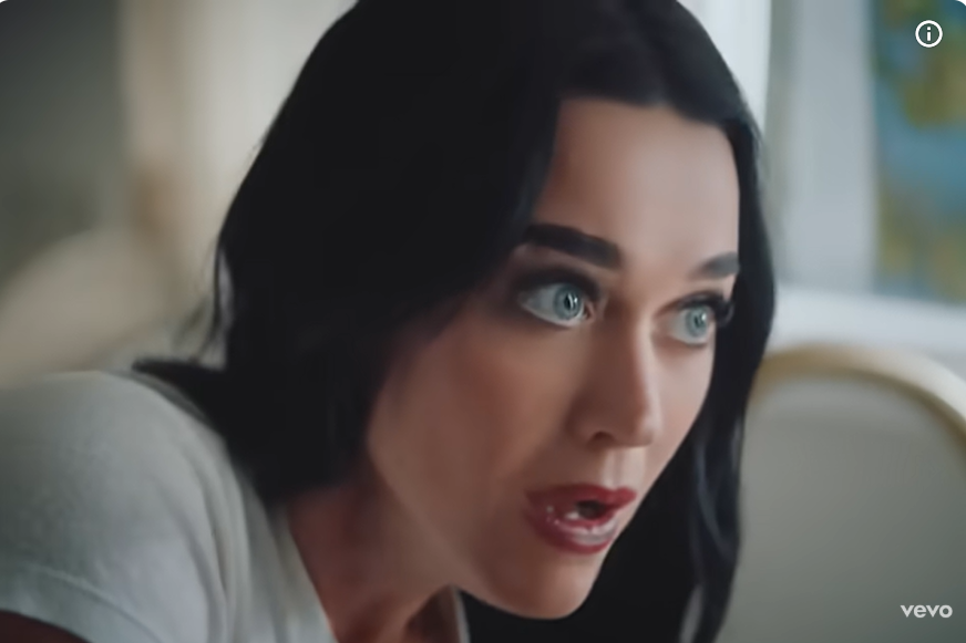 Katy Perry gives a shocked look as seen in her music video "Bandaids," dated November 7, 2025. | Source: Youtube/KatyPerry