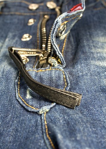 A closeup of a zipper with string detail. | Source: Shutterstock.