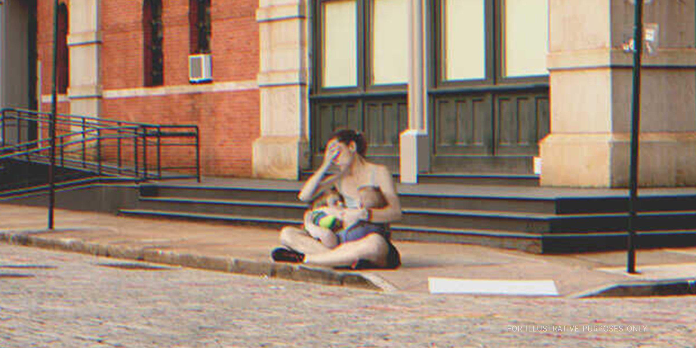 Woman with two children sitting on the street. | Source: Getty Images