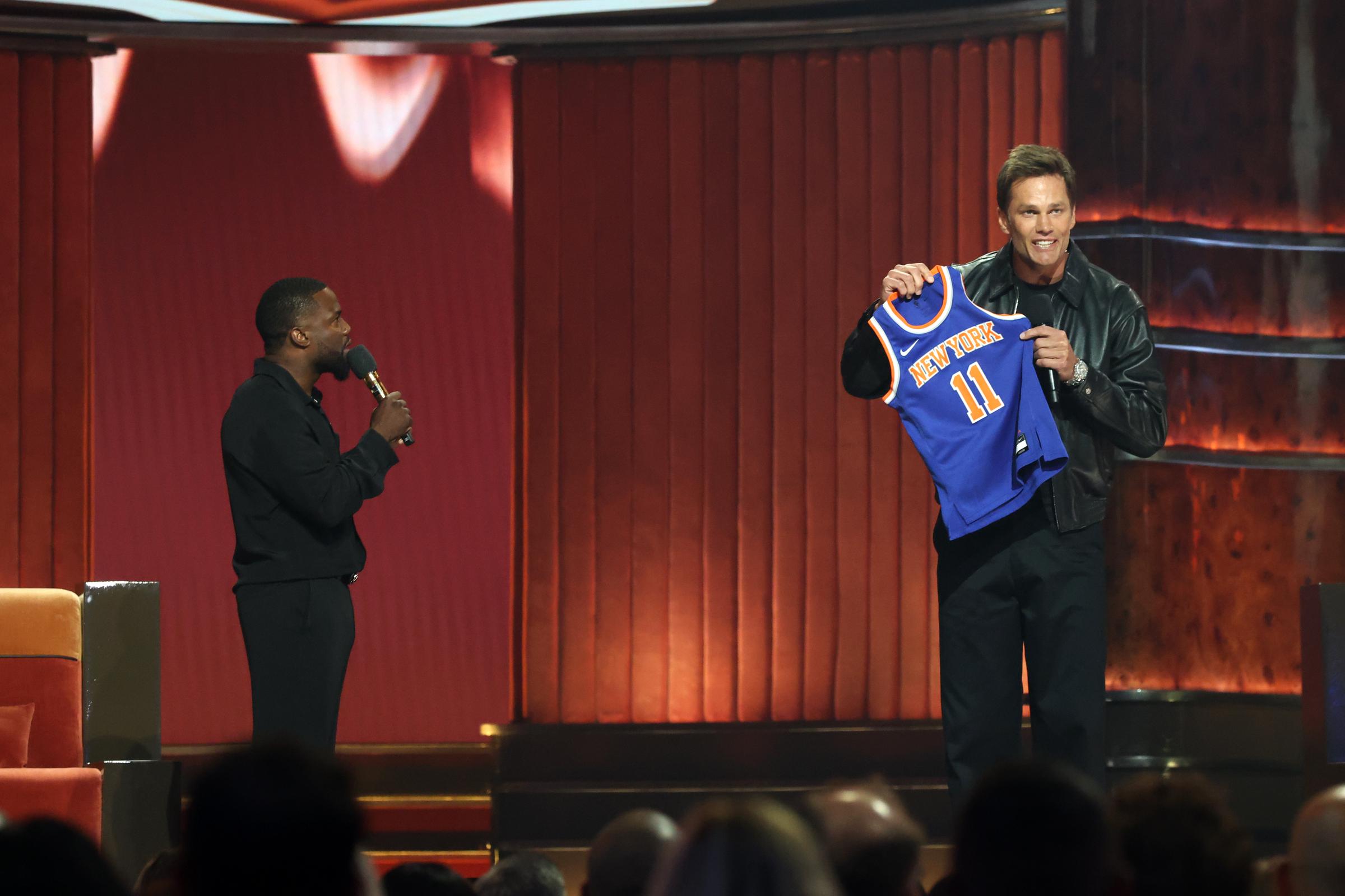 Kevin Hart and Tom Brady speak onstage during Netflix Is A Joke Festival Presents: The Roast of Kevin Hart at The Kia Forum on May 10, 2026, in Inglewood, California | Source: Getty Images
