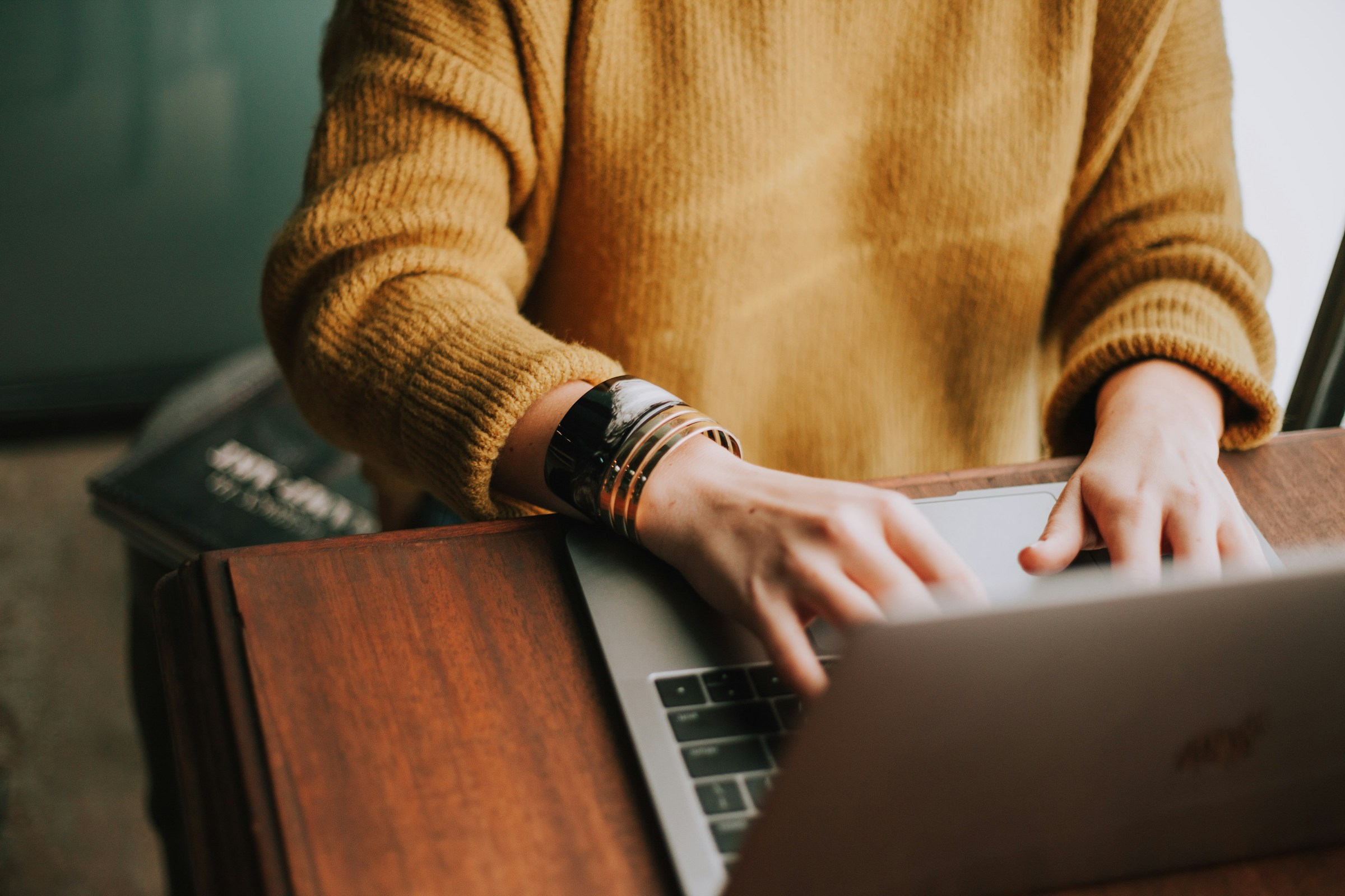 A closeup of a woman working on her laptop | Source: Unsplash