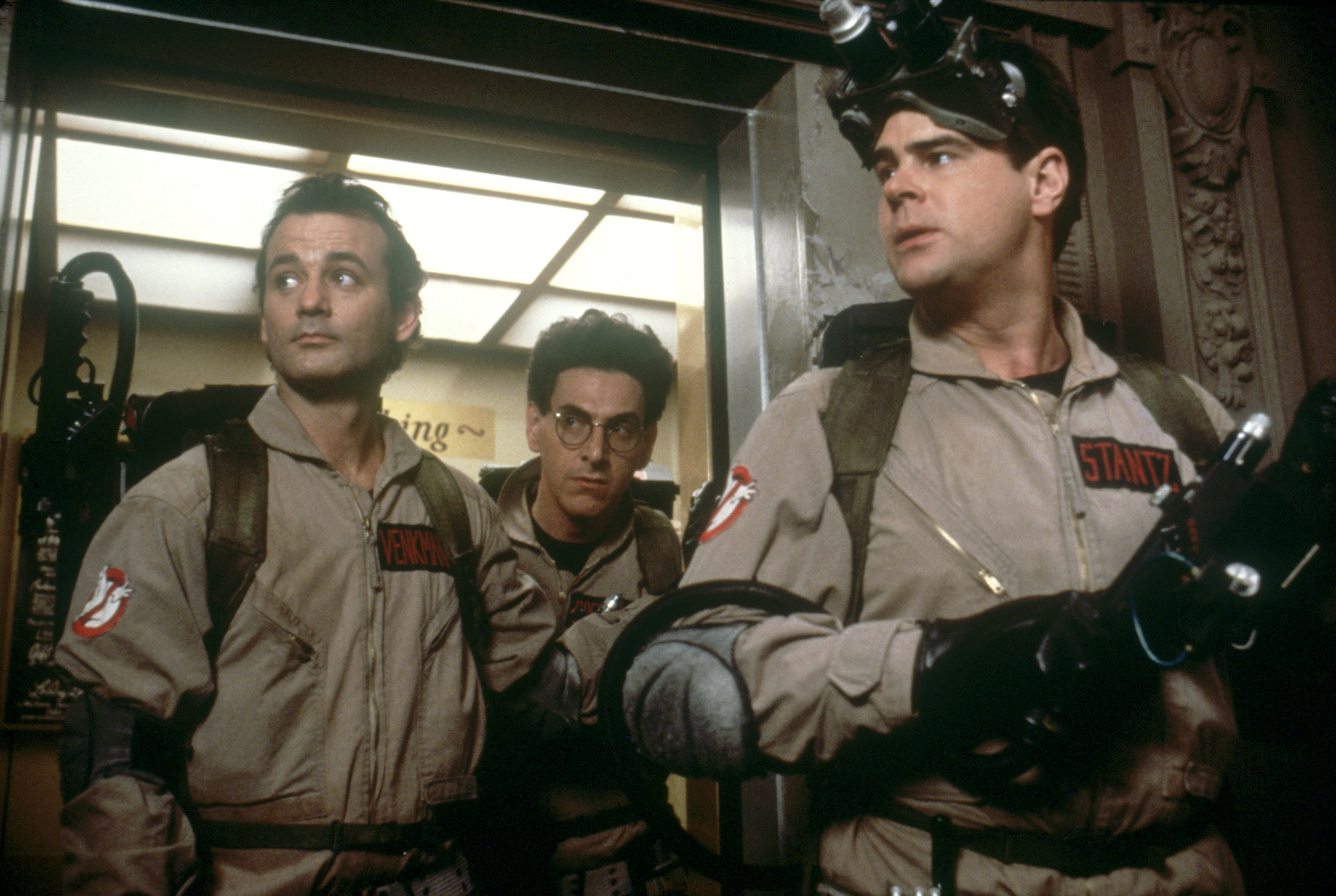 American actor Bill Murray, actors and screenwriters Harold Ramis and Dan Aykroyd on the set of "Ghostbusters," directed by Ivan Reitman | Source: Getty Images